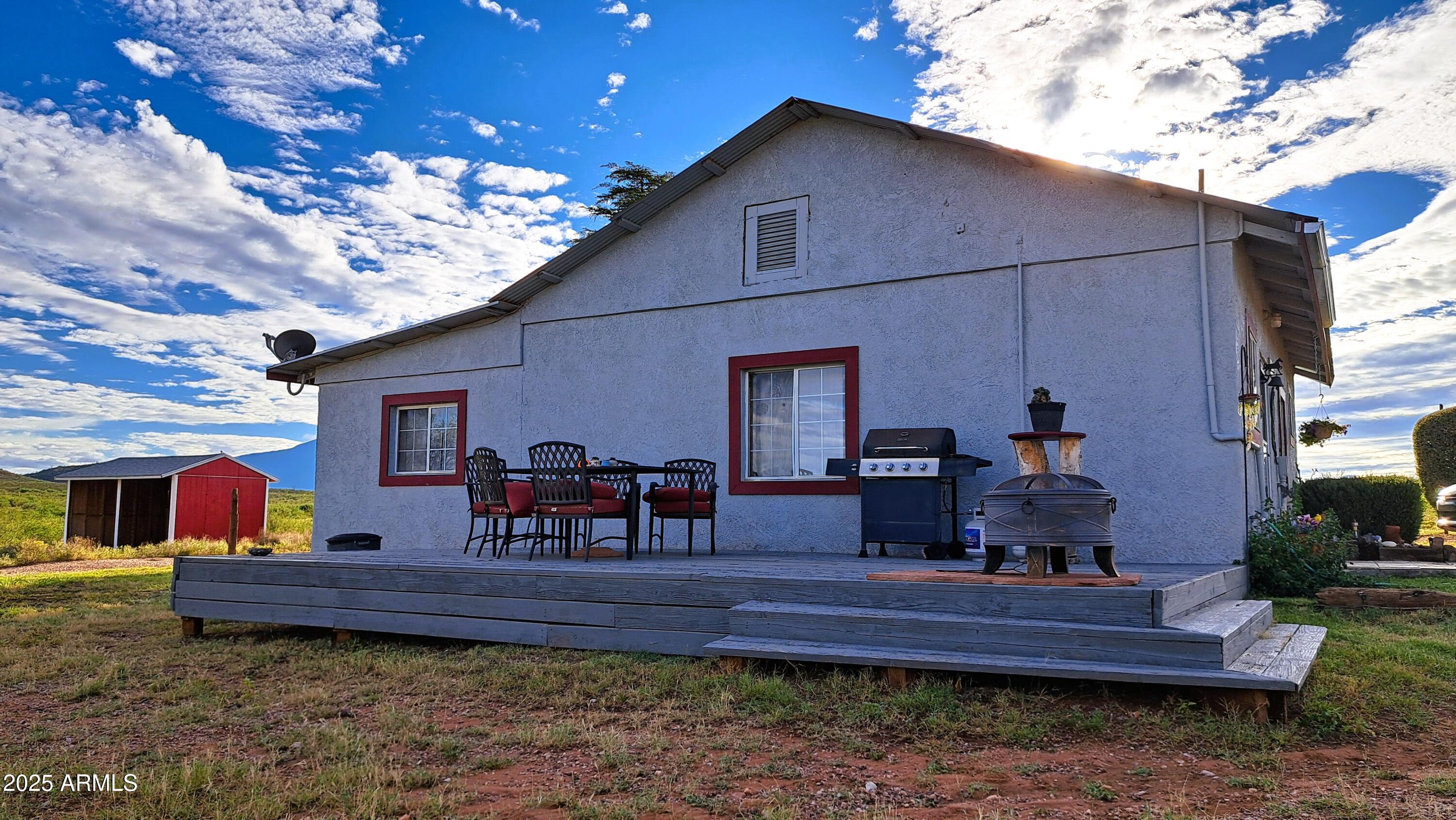 Exhilarating horse property 4 miles from Bisbee's historic Vista Park and City Hall YET it feels like 50 miles away. Country living at its best.  8 inch cinder block
walls provide utility savings. You can see by the photos how expansive the property is due to the large neighboring ranches.  Lots of creature comforts in the well-maintained home such as --Central AC/heat, dual pane windows, ceramic tile and a newly remodeled kitchen with a ton of overhead lighting, granite and butcher block counters, island and upgraded stove.  The full bathroom was redone as well, with a granite vanity.  The living space is nicely designed with openness in mind.  The master has an attached den/office/ workout room with lots of natural light.  A 30' x 15' workshop/bonus room with power was recently built. It could be converted into living space on the RU-4 property. A large deck on the east side of the home is a great spot to grill, admire the scenery. There is also a 45' x 30' concrete foundation that could be used to build a garage or whatever your needs may be.  The 5-acre parcel is fully fenced and then cross fenced for a 3-acre pasture with a mini-barn.  There is also a separately fenced area with 2 dog houses.  Southwest Gas so no need to deal with propane.