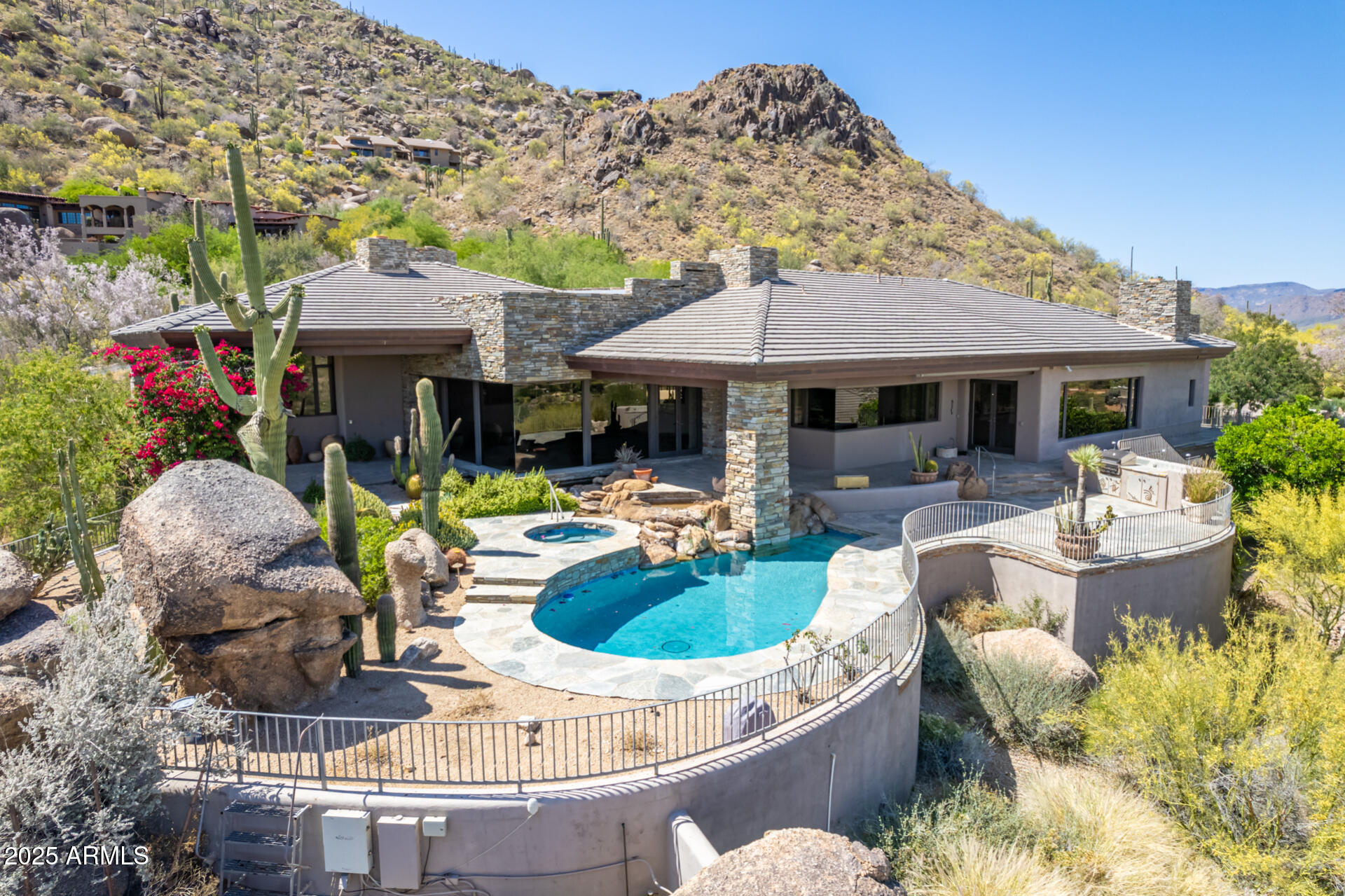 If views, privacy, and luxury are important, this mountainside estate will not disappoint! Designed by renowned architect Allen F. Tafoya & nestled high on the iconic Black Mountain in highly desired town of Carefree, AZ—where timeless desert beauty meets refined elegance. Perched on 2.5 acres of pristine Sonoran Desert, offering sweeping, unobstructed views of the Boulders Golf Course & surrounding mountain vistas, while delivering peace, privacy, & breathtaking scenery in every direction. The property features a chef's dream kitchen w/ 6 burner gas cooktop & griddle, commercial-grade fridge/freezer, 2 dishwashers, large walk-in pantry, & spacious island. Walls of glass are the only thing separating you from the stunning natural desert & absolutely amazing views of the valley. (MORE)