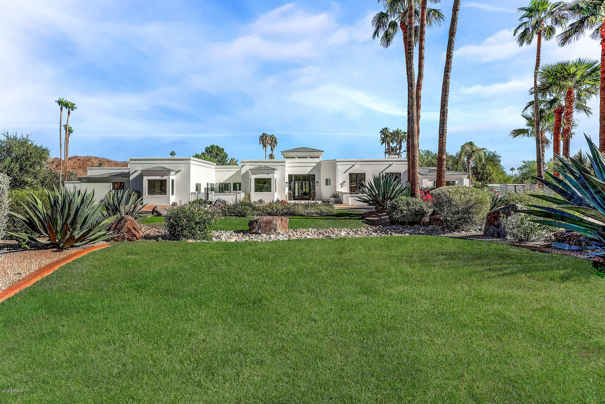 NEW Stylish Modern Estate completely REBUILT and completed in 2019. The crisp lines of this design flow seamlessly throughout the 7,000+ square feet. This modern transitional home is decorated in a neutral color palette ranging from light and bright to boldly dark accent walls excellent at drawing focus around the many fireplaces. The architecture is designed to thrill and delight the most discerning of refined senses with upgraded top-of-the-line everything. Chef grade gourmet kitchen is well equipped with Advanced State-of-the-Art Stainless Steel Appliances including a Wolf 6 burner gas cook top with 2 ovens, water spigot, and impressive Stainless Steel Hood. The edgy flair of the back splash compliments the Quartzite counter tops impeccably. A wine fridge is situated between the two doors of the Stainless Steel Fridge showcasing the attention to detail and convenience of design exclusively reserved for luxurious and affluent high end estates. The inspired master suite includes a sitting area, fireplace, and double doors leading to a private courtyard. Symmetry and balance of design grace the master bathroom presenting all the amenities including glass enclosed shower, vanity with double sinks, bathtub, and separate toilet rooms. The decadent master closet room sports a center island dresser, 3 windows, and exquisite extra lighting. This estate also offers formal living room, formal dining room, wet bar with fridge, skylights, folding exterior glass doors, guest Casita with separate entrance and other features too numerous to list. Patio with outdoor kitchen is perfect for entertaining, relaxing, and enjoying the mountain views. Impeccably manicured grounds feature fire pit, pool, and spa. Gated community also provides access to amenities including a pool. This highly desirable modern estate is unusually exceptional and likely to be quickly acquired.