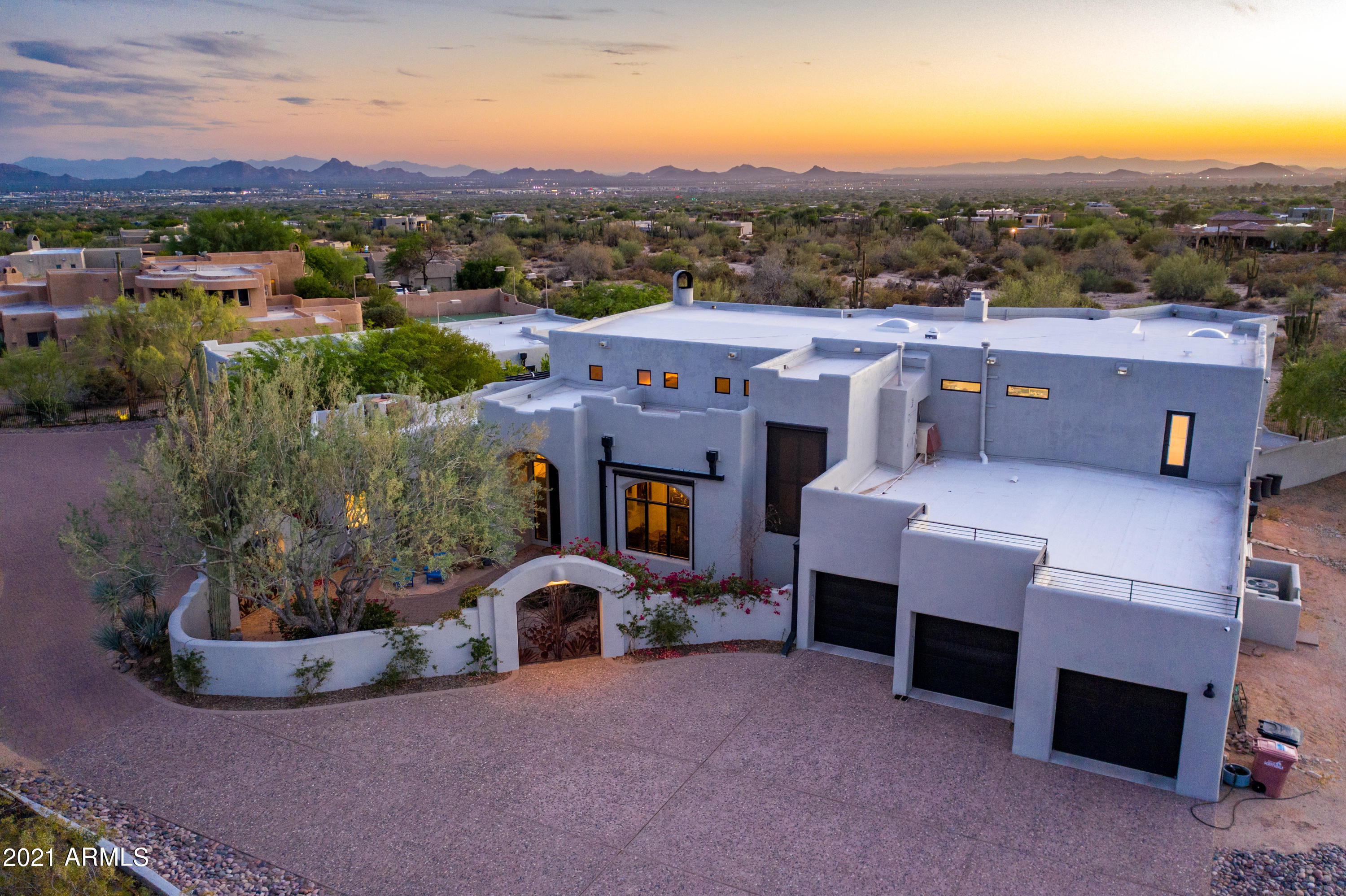 Exceptional Pinnacle Peak Vista estate in the heart of North Scottsdale with separate guest house.  Exclusively situated on a 1.5 acre lot surrounded by natural preserve with a unique prestigious arrival via a private gated drive. Boasting extraordinary mountain vistas of Pinnacle Peak, the McDowells and south mountain ranges with spectacular city light views. Greeted by a lush mature landscaped courtyard and expansive paved entry, this functional great room home plan is bursting with character and personality.  With the main home living space at 4,914 sf, plus an 1,848 sf detached private guest house with living room, two bedrooms, kitchenette, 2 car garage, covered patio and backyard party grill.
Spacious great room with eye-catching log wood ceiling features an oversized wet bar with weathered leather granite countertops, generous serve top seating, ice maker, sink, wine and beverage fridges and seamlessly opens with 16' glass Nano doors to outdoor living. Modern wide plank hard wood flooring flows throughout.  State of the art kitchen opens to outdoor kitchen and seated serve top with large accordion window, and features a commercial grade stainless steel Imperial range with 6 burner, double oven and griddle.  Generous island with underlit granite top, stainless-steel Sub-Zero side by side fridge/freezer, and two Bosch dishwashers.  Peaceful master retreat offers amazing views, fireplace, dual balcony access and sauna.  Picturesque panoramic mountain and city views from vast balcony with access from upstairs loft, master and back yard full size staircase.  Resort style backyard with expansive covered patios with ceiling heaters, outdoor kitchen, heated pool, large grass areas, fireplace and full pool bath.  Six car garage with 3 car garage with 4th tandem in main house and 2 car in guest house.  Premier AZ Sonoran living with convenience to North Scottsdale amenities.
