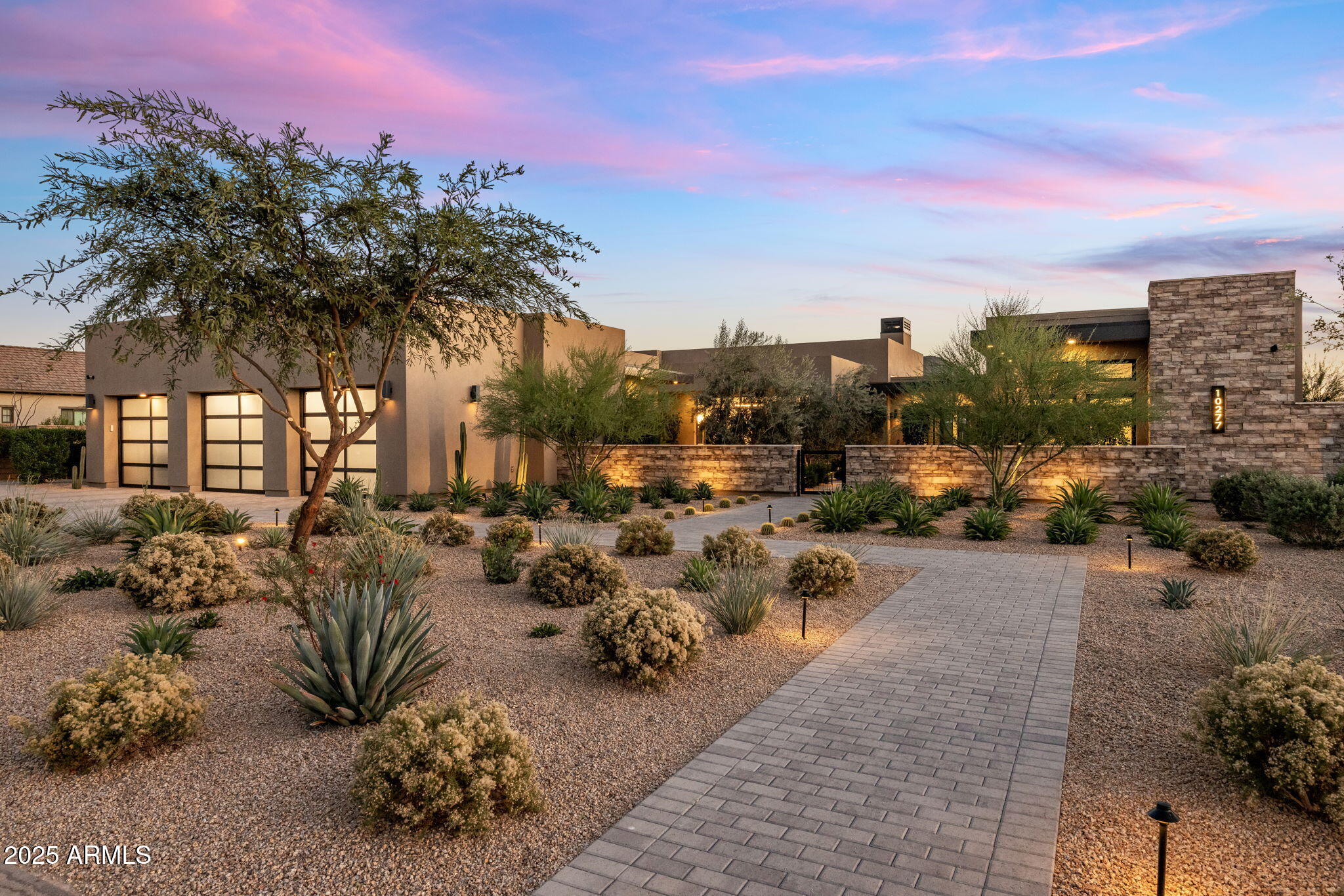 Award-winning contemporary estate in Scottsdale's prestigious 85255 zip code, built in 2023, is ideally oriented north-south to capture exceptional natural light. This private residence boasts sweeping mountain views of the McDowell Mountains, Troon Mountain, Pinnacle Peak, and a glimpse of Camelback Mountain, offering a peaceful retreat just minutes from the Loop 101, Scottsdale Quarter, Kierland, and world-class golf.

A lush courtyard leads to a refined entry where gardens and mountain vistas immediately set the tone. This thoughtfully designed 4,931 square foot home features 4 bedrooms, 4.5 bathrooms, a gourmet kitchen overlooking main living areas, 4 car garage, and a generous backyard. The home boasts marble and quartzite countertops, wide-plank wood flooring, Wolf/Subzero appliances, Butler's pantry with undercabinet fridges, designer lighting, elevated ceiling heights, Sonos Audio Visual system with speakers throughout, custom heated pool including water features, spa, outdoor cooking area and impeccably manicured landscapes.

Step into the great room where tall ceilings are anchored by expansive retractable glass walls and covered loggias, seamless indoor-outdoor flow. The primary bedroom suite features a spacious walk-in closet, a luxurious bathroom featuring custom cabinetry, designer lighting, handmade hardware, marble counters and floors, walk-in shower, soaking tub with telescoping door that opens to a private sanctuary garden with stunning mountain views. 

The beautiful landscape envelops the pool/spa and evokes a reverence for the art of nature, emulating classic European designs graced by olive and fruit trees, verdant hedges, rose gardens, organic herb garden, private Zen garden, and 2 activity lawns with lush sod offering a respite for the soul. A tranquil gem in the Sonoran Desert awaits.