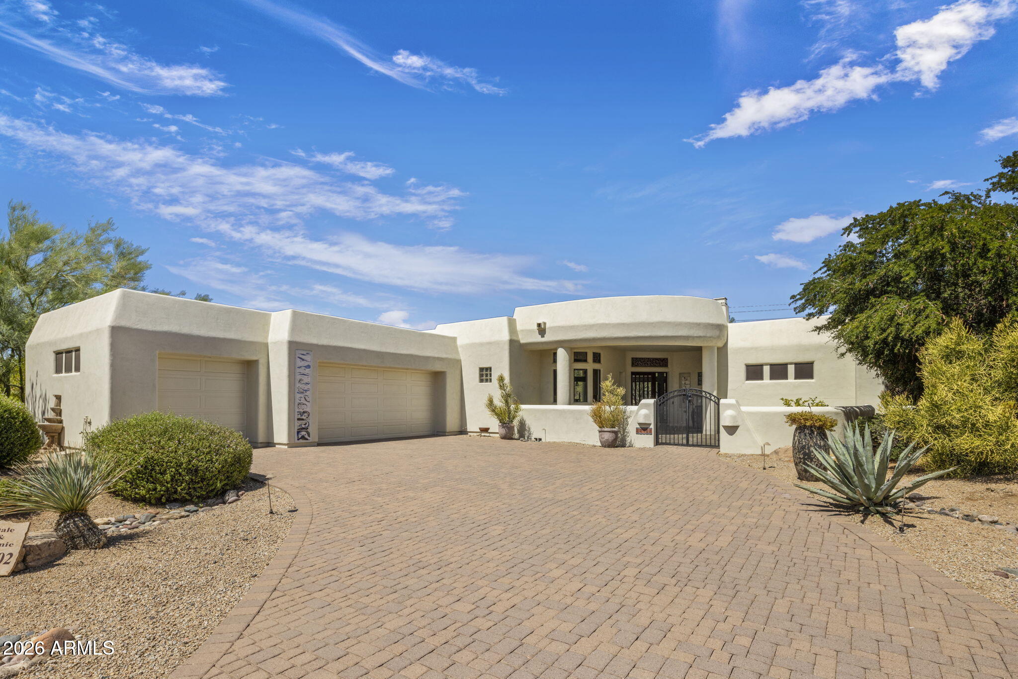 Step beyond the ordinary and discover this one-of-a-kind custom residence by Phoenix Smith, tucked inside the gated golf community of Tonto Verde. A private courtyard welcomes you into a light-filled home where soaring ceilings, slate tile, rich wood flooring, and recessed lighting create an inviting atmosphere throughout. The thoughtfully designed split floor plan features a private primary retreat with an enclosed spa, while the guest suite offers its own ensuite bath and direct backyard access. A versatile den with a two-way fireplace opens to the patio, creating the perfect office or reading space. The chef-inspired kitchen showcases granite counters, dual islands, a cooktop, built-in workspace, and an oversized walk-in pantry. Outside, enjoy a spacious, tree-lined backyard designed for privacy, pets, and outdoor living, complete with a fully fenced and snake-proof perimeter. The oversized 3-car garage offers epoxy floors, built-in storage, and a dedicated mini-split system. A newly constructed drywall enclosure creates a separate climate-controlled space within the garage, ideal for a workshop, craft room, hobby space, home gym, or whatever suits your lifestyle. Two new Lennox HVAC units installed in 2025. A truly special home that blends character, comfort, and versatility in one exceptional package.