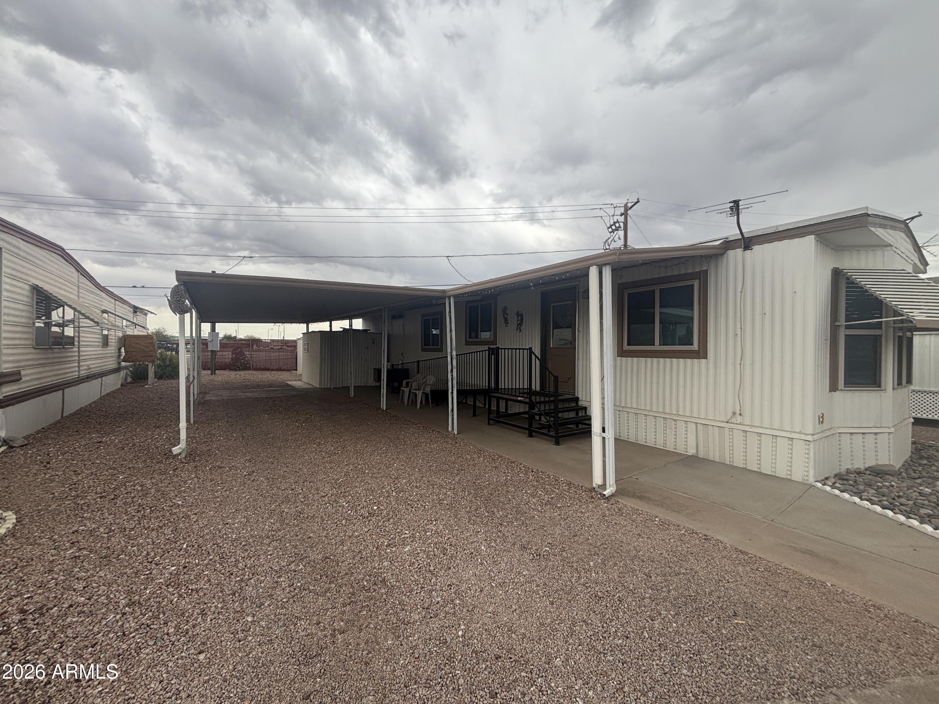 MOTIVATED SELLER! Beautiful Mountain Views of the Superstition Mountains! Conveniently located near restaurants and shopping, this home is a quick in and out being towards the front of the community.  This well maintained home boasts a heat furnace, gas stove for your culinary needs! Lifetime single panel metal Insulated Roof for long lasting roof protection. Double paned tinted windows for energy efficiency and steel doors! This home comes mostly furnished, both sheds have electricity and will come with the home! Modern railing and ramp for accessibility!