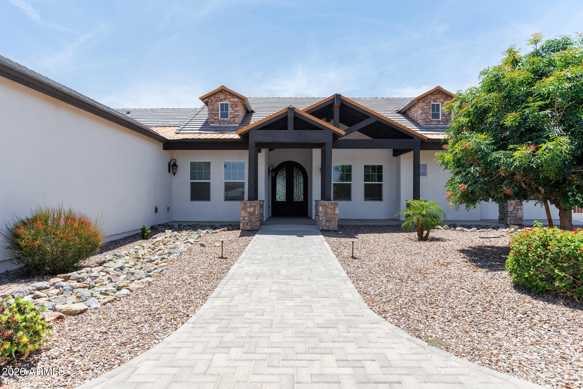 This home is truly one of a kind!! Built in 2021 this large single story beauty is exceptional from the moment you pull up to the horseshoe paver driveway! It has a stunning copper roof on the front and back of the home! Once you walk in you are greeted by a custom double door! Inside you will find an incredible open floorplan with a fireplace and custom built-ins.  You have a chef's delight in the kitchen! With an oversized kitchen island, a double oven, 5 burner propane range, pot filler, drawer style microwave and a custom range hood there is nothing missed.  This home features one bedroom with its own private ensuite and two guest bedrooms with a jack and jill bathroom.  Just off the living area is a spacious den equipped with its own wet bar! The primary suite is very spacious and