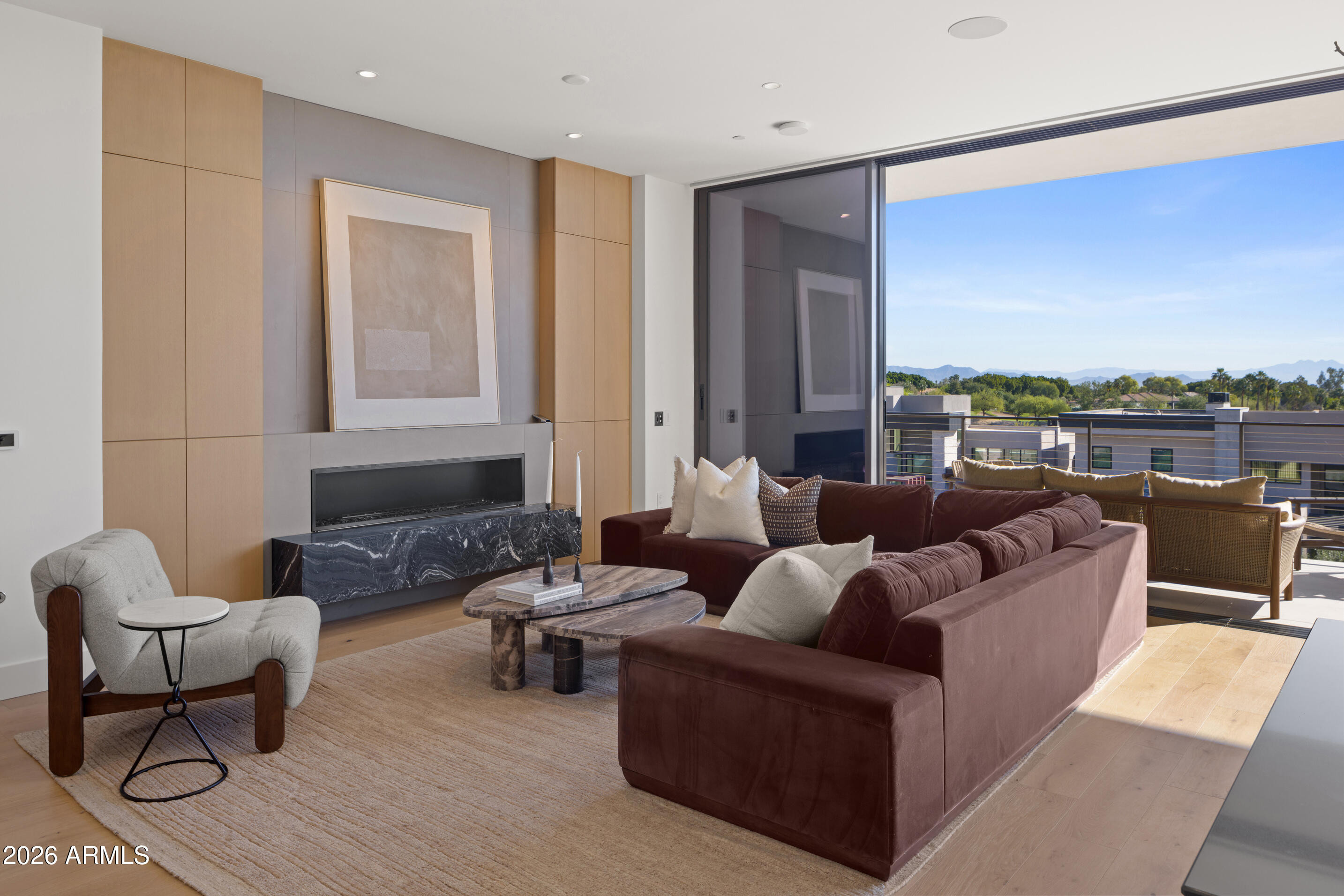 BRAND NEW/JUST COMPLETED, this UPGRADED rare 3 Bd/4Ba + den  CORNER residence offers designer-driven living and PANORAMIC VIEWS of the McDowell Mountains, Four Peaks, Phoenician Golf Course, + Scottsdale skyline. Over $250k IN UPGRADES, including $135k of upgraded BULTHAUP CABINETRY and 78K SMART HOME. The expansive great room spans family, dining, and living zones, framed by stacked glass doors and anchored by a sleek marble fireplace. Chef's kitchen boasts a reconfigured island for entertaining and flow, dual Sub-Zero refrigerators +WINE WALL, and Wolf induction range. A spacious WRAPAROUND TERRACE W/BBQ completes one of the most comprehensively upgraded residences at Ascent, and includes access to private rooftop terraces, pools, fitness facilities, and the adjacent Phoenician Resor