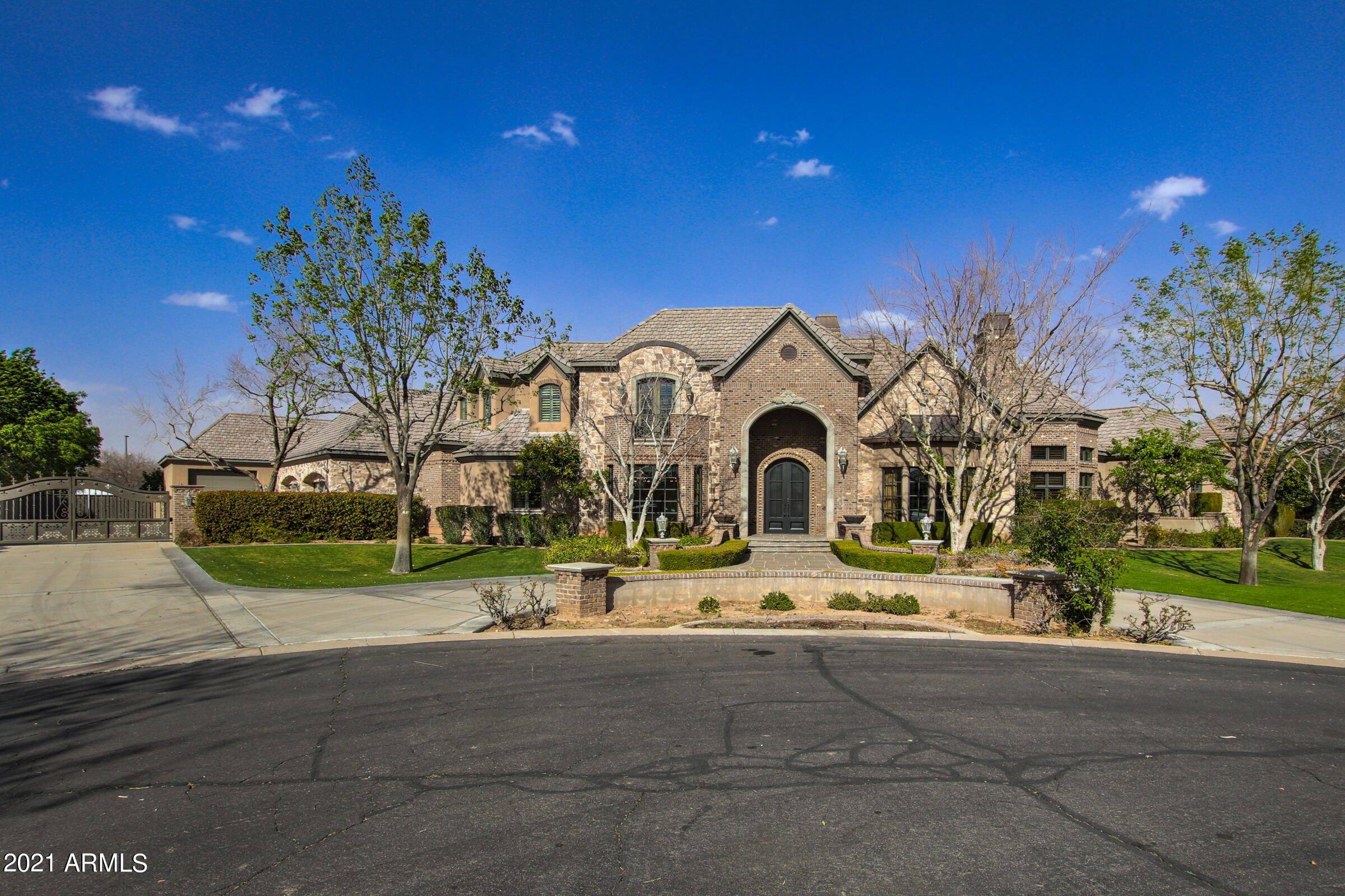 Elegant basement home estate in Circle G close to both the US 60 and the 202 freeways! Entertainers dream home! Cul-de-sac lot! Private motorized entry gate to garage area. 6 bedrooms, 6.5 bathrooms+office+home theater in basement. Heated diving pool with water slide and spa. Kitchen features custom alder wood cabinets, Italian marble and wood floors,high end wolf and Sub-Zero appliances, gas range, ice maker and oversized island with prep sink. Giant walk-in pantry. Soaring 24 foot ceilings in kitchen and great room. Large master suite on main floor with private fireplace and sitting area and doors to access the backyard. Large his and her closets with high end built-in shelving and cabinets. Dual vanities, large soaking tub and oversized walk-in shower with dual shower heads. All bedrooms have walk-in closets and private bathrooms. Full basement with theater room, second laundry room, 3 full bedrooms and 2.5 bathrooms. Exit the basement to the attached courtyard with stairway to the backyard. Private exercise room off of courtyard. Second story with two large bedrooms with private bathrooms. Extended depth 4 car garage has a temperature controlled storage room behind and craft room above. Large detached temperature controlled RV garage with built-in basketball court! Perfect yard for entertaining with huge covered patio, travertine pavers, built-in grill, pool and sitting area next to a grand double sided fireplace with fire pots on both ends! Half bath and shower adjacent to pool area. Much, much more, this is one of the nicest homes in the entire east valley!