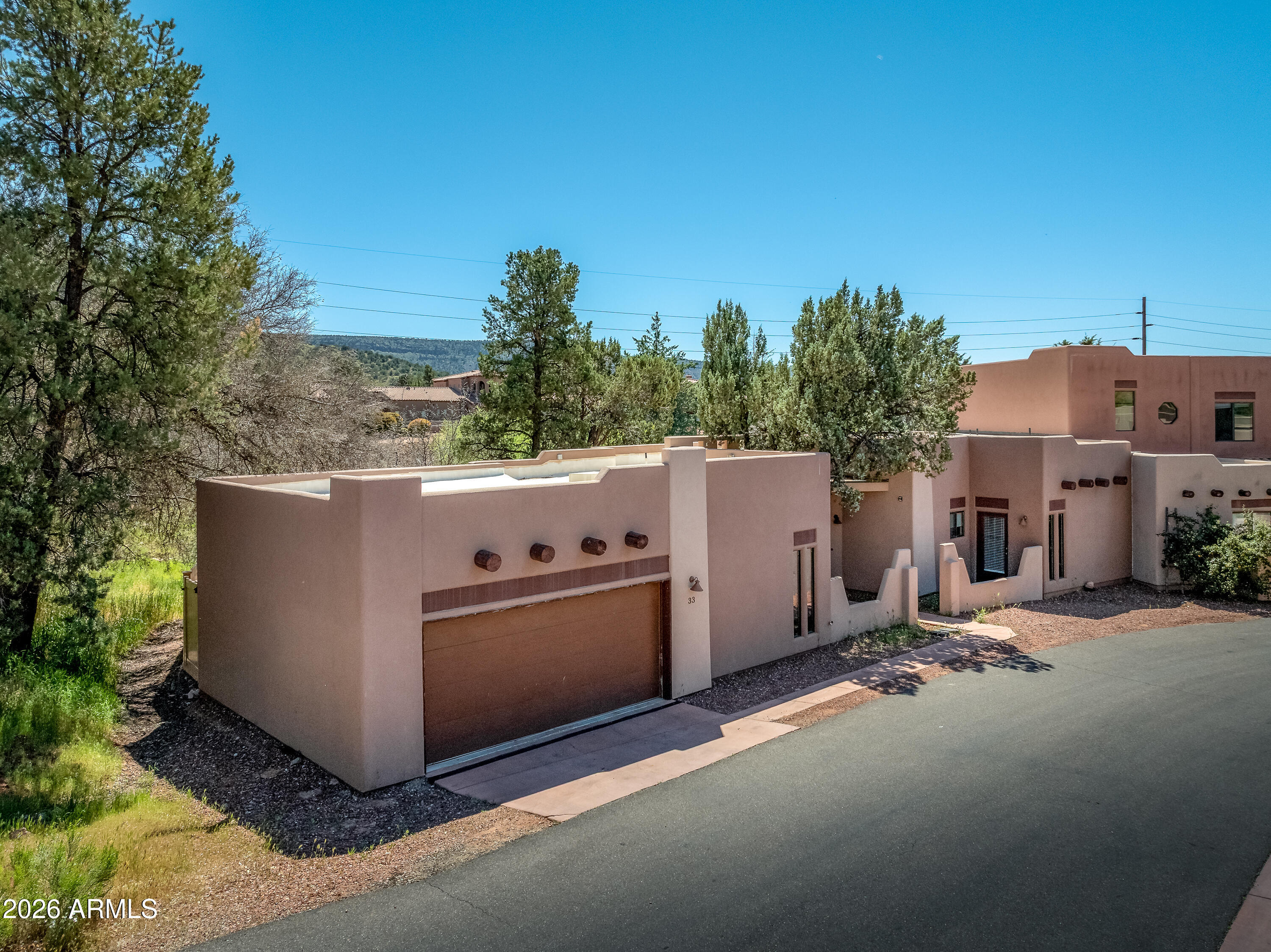Sedona -Turnkey Village of Oak Creek townhome used as a short-term rental well managed by Sedona.org.  This beautifully maintained single-level 3BR/2.5BA home has welcomed guests since 2017, delivering consistent returns in one of Arizona's most in-demand short-term rental markets. Open-concept layout, soaring ceilings, granite countertops, stainless steel appliances & large kitchen island. Steps from Sedona Golf Resort, the Collective Plaza, restaurants, wine bar & world-class hiking trails nearby. Breathtaking red rock views throughout.  Professional management in place with low-friction ownership from day one. 2025 financials available - ask your agent. Art and Desk do not convey. Why This Property -- The Investment Case
33 Monterey Circle has operated as a short-term rental since 2017 -- nearly a decade of guest bookings, reviews, and repeat visitors.  This isn't a value-add project or a lease-up story -- it's a stabilized asset with documented financials, an established guest reputation, and zero operational lift required on day one. For buyers seeking a passive income property in one of Arizona's most recognizable destinations, this is a rare low-friction entry point.
Sedona's STR market draws visitors year-round for red-rock hiking, arts culture, and wellness retreats, and 3-bedroom homes lead the market with an average daily rate of $416 and average annual revenue approaching $80,000 -- making this property well-positioned for revenue optimization under the right pricing strategy.
The Neighborhood -- Village of Oak Creek
Nestled amid the dramatic red rock landscapes of northern Arizona, the Village of Oak Creek offers a peaceful yet scenic counterpart to nearby Sedona -- quieter and more residential in feel, yet with full access to the area's iconic geological wonders. Sedona For STR guests, that balance is a selling point: they get Sedona's scenery and trails without the congestion of uptown, and they're within minutes of everything.
The area receives over 275 sunny days per year, with snowfall rare and temperatures moderated by the surrounding red rock formations -- a year-round draw for visitors from Phoenix, Los Angeles, and beyond.
What Guests Come For -- The Experience
Steps from the front door, guests find the Sedona Golf Resort and the Collective Plaza -- a vibrant hub of dining, boutique shopping, and spa experiences. The Village of Oak Creek is also home to some of Sedona's most recognizable red rock formations, including Bell Rock and Courthouse Butte, with trail access practically at the doorstep.
Top guest experiences in the area include:

Bell Rock & Courthouse Butte Trails -- among Sedona's most iconic and accessible hikes, drawing hikers and photographers year-round
Chapel of the Holy Cross -- a landmark architectural and spiritual site carved into the red rocks, just minutes away
The Collective Sedona -- an open-air plaza with acclaimed dining (including Cucina Rustica), spas, boutiques, and a gym
Sedona Golf Resort -- a championship course with sweeping red rock views, walking distance from the property
Red Rock Scenic Byway (SR-179) -- one of America's most scenic drives, passing directly through the Village
Jeep & ATV tours, vortex sites, hot air balloon rides -- experiential activities that keep Sedona on bucket lists worldwide

The Bottom Line
Sedona isn't a trend -- it's a perennial destination with a loyal, returning visitor base. The market's occupancy stability ranks above average, providing a dependable baseline for cash-flow planning. With management in place, financials in hand, and a guest-proven track record dating to 2017, 33 Monterey Circle offers something increasingly rare: a Sedona STR you can own without starting from scratch.
2025 year-end financials available upon request. Buyer to verify all STR regulations and income figures independently.
