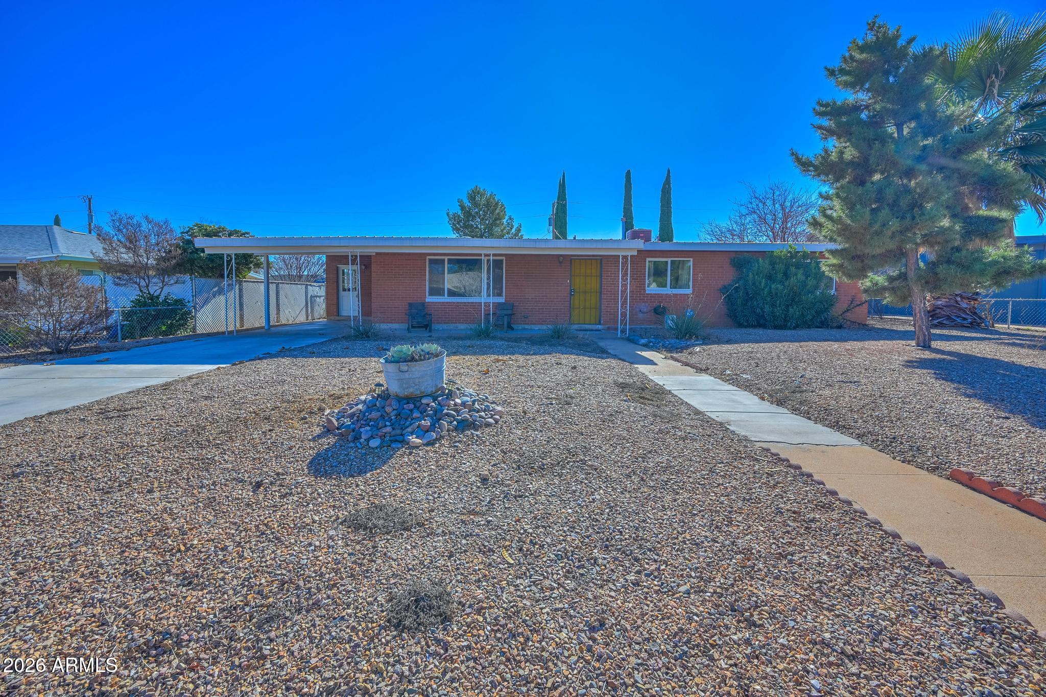 LOOK HERE! This affordably priced 3-bdrm 1668 SF home offers a great opportunity in a desirable mid-town location near Ft Huachuca. The ample living area offers wood-laminate flooring and the kitchen is perfect for cooking & baking. Corian countertops, stainless appliances, an electirc cooktop, a breakfast bar, cabinet & counter space, and in-kitchen dining. The primary bedroom includes an en-suite bath with a walk-in shower. Two additional bedrooms with a nearby full guest bath. There's also a spacious indoor laundry room for added convenience and storage. Outside, enjoy a generous backyard with grass, covered patio, and storage shed. A durable metal roof, carport, driveway parking, and covered entry complete this value-packed home ready for your personal touches. Come see today!