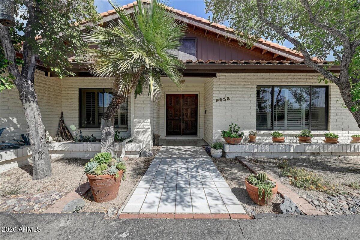 MAJOR PRICE REDUCTION! Nestled on .98 acres in the quiet community of Carefree Shadows, this custom Carefree desert home offers 2,941 square feet of architectural warmth, spacious living areas, and a flexible floor plan. Although older, the home showcases dramatic wood beamed ceilings, rich wood textures, abundant natural light, and a true indoor outdoor Arizona feel throughout.
The split bedroom floor plan features expansive living and entertaining spaces including formal dining, a very large family room with a striking rock fireplace, and an enormous enclosed Arizona room overlooking the desert landscape and mature saguaros. North south exposure helps provide balanced natural light throughout the home, while ceiling fans and zoned HVAC add comfort and efficiency. The massive upstairs loft offers exceptional flexibility with built in shelving, vaulted wood beamed ceilings, a full bathroom, and a walk in closet. Ideal as a private office, den, creative studio, media room, or potential future guest suite conversion, the space adds a unique architectural element rarely found in homes of this era.
The spacious primary suite includes a large cedar lined walk in closet and generous storage. A separate laundry room and additional storage areas throughout the home provide functionality and convenience.
Outside, the property embraces the relaxed Carefree lifestyle with open desert views, mature landscaping, and room to personalize or expand outdoor living spaces. A large fenced and gated side area currently serves as a spacious dog run but could also be adapted for gardening or other protected outdoor uses. A detached oversized shed with electricity and water connection offers additional possibilities for a workshop, hobby space, art studio, future conversion with imagination and vision.
Located in desirable Carefree, Arizona with a low HOA fee, this property offers the laid back desert lifestyle the area is known for, with slightly cooler temperatures, star filled night skies, nearby hiking and golf, and the charm of the downtown Carefree area. This is a rare opportunity to own a character filled Arizona home with architectural warmth, flexible living space, and timeless desert appeal.