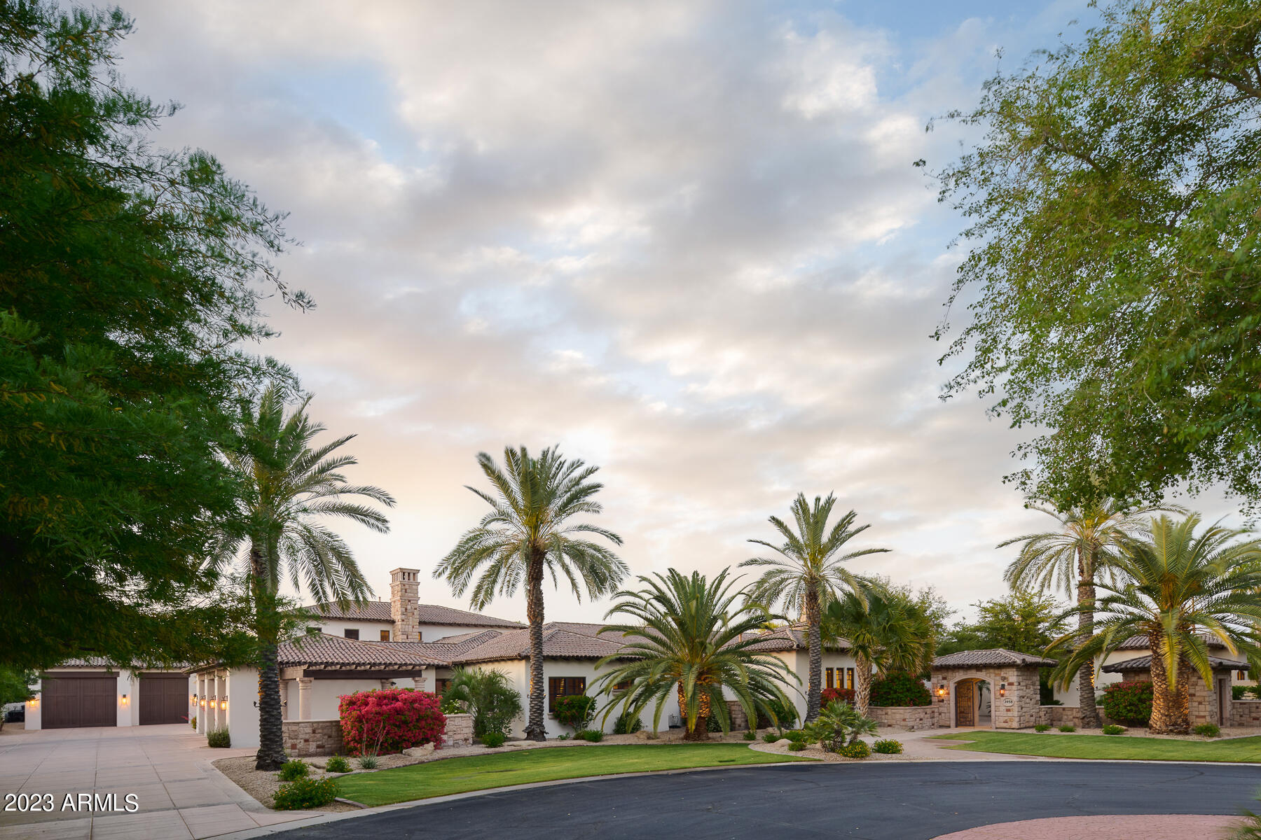 Experience the ultimate in refined luxury and sophistication. This Spanish inspired estate boasts a perfect combination of world-class luxury and resort-style relaxation just a short drive away from the hustle and bustle of Scottsdale and Paradise Valley. Step inside, and you'll be greeted by gorgeous woodwork, canterra accents and custom ceiling treatments throughout the home. The gourmet kitchen features double beveled granite and exquisite woodwork. The 2-story library features an artful hand-painted world map on the ceiling. The master suite is a tranquil retreat complete with a private patio, canterra fireplace, and large spa jetted tub. The ultra private backyard oasis is an entertainer's dream, featuring a sparkling play/lap pool with a boulder water slide, grotto, waterfall, spa firepit, BBQ with serving bar, and ample space for entertaining guests. This home also features an exercise room, theatre/game room, and craft room, making it the crown jewel of Rosewood Estates. Don't miss this rare opportunity to own this exceptional property.