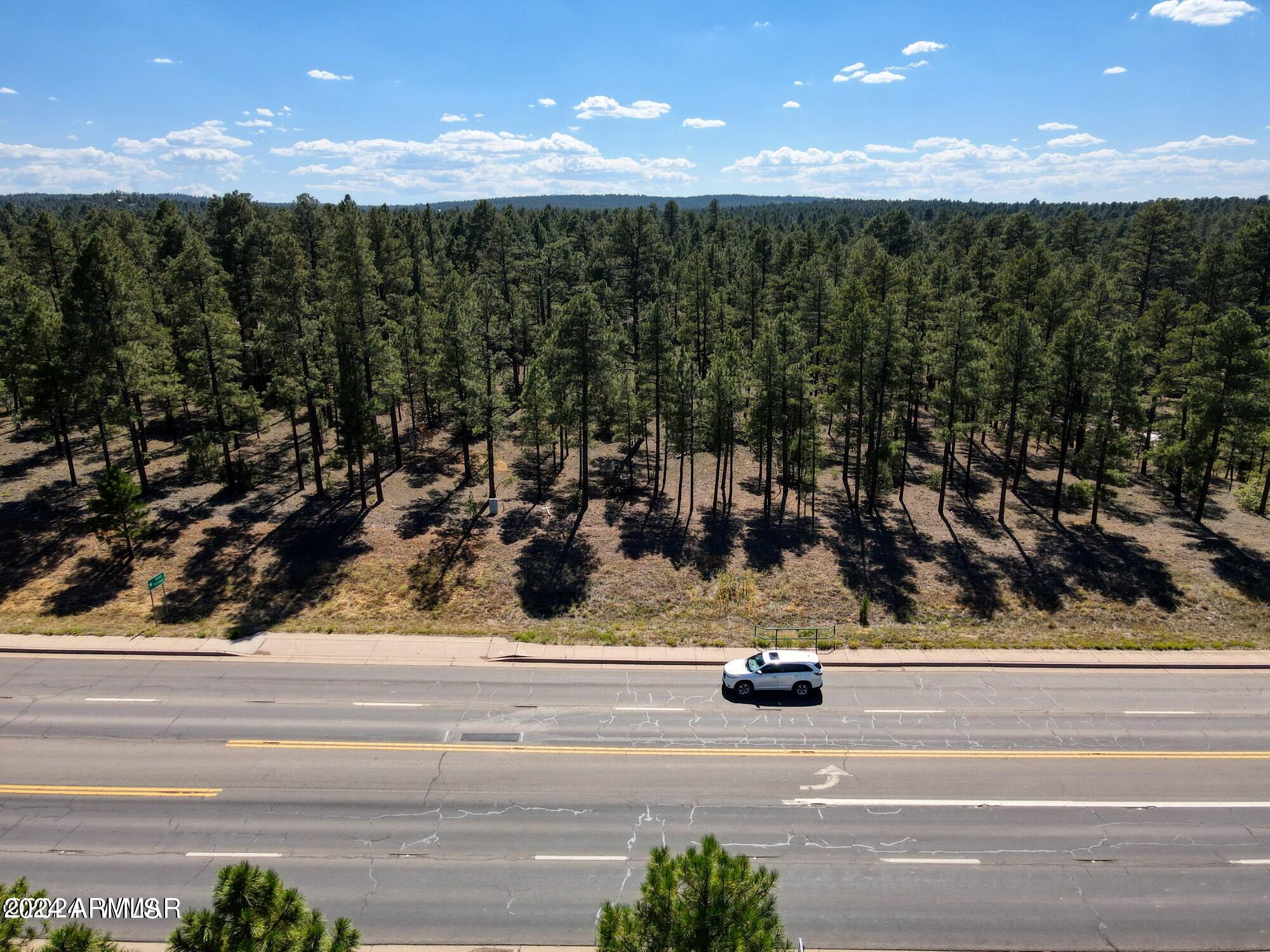 Two full commercial acres located in town with extensive frontage along Highway 260/Clark Rd. Positioned directly across from Bison Preserve, The property features tall pines for aesthetic appeal and offers dual access from the corner of 30th Street. Come take a look! APN 309-37-021B is also included. For Sale or Possible Trade.