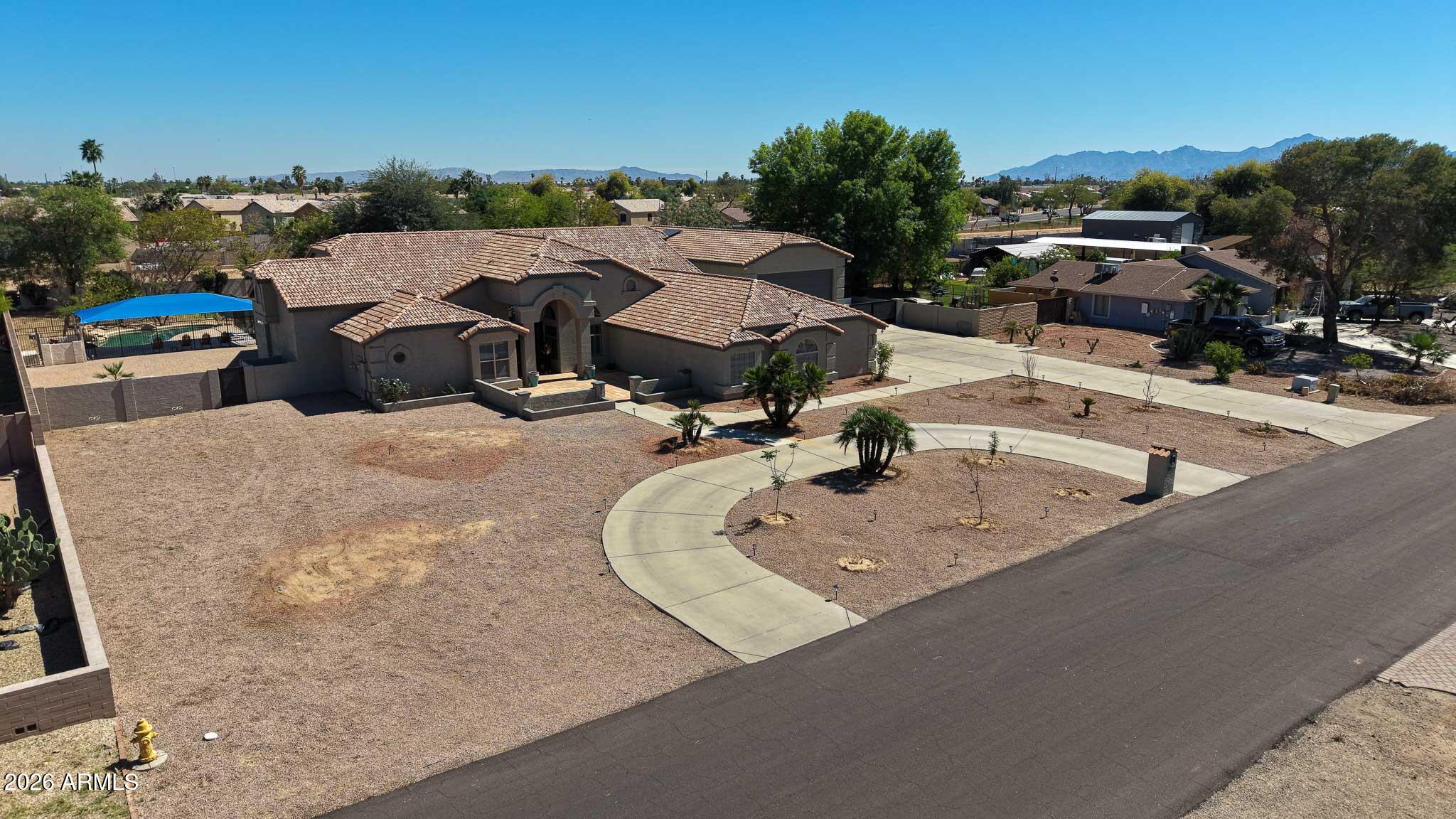 Experience luxury living on a full acre with no HOA--this completely renovated home in Camelback Farms is the total package. Featuring a rare detached 60' RV garage, dual primary suites, RV gate, and endless parking space, this property offers both versatility and upscale design.

Spanning 3,568 sq ft, this 4-bedroom, 3.5-bath home plus den showcases a bright open floor plan with soaring ceilings, smooth-textured walls, and custom Venetian plaster finishes. Expansive 16' and 11' multi-slide doors create seamless indoor-outdoor living.

The designer kitchen is equipped with a large island, quartz countertops, slim shaker cabinetry, under-cabinet lighting, gas range (propane), drawer microwave, and a 42'' Monogram refrigerator. The main primary suite features dual custom closets, a spa-inspired bath with a freestanding tub and separate shower, and private backyard access. A secondary primary suite offers its own en-suite bath--ideal for guests or multigenerational living. Two additional bedrooms share a Jack & Jill bath.

Upgrades include porcelain plank tile flooring throughout, modern interior doors, upgraded hardware, LED lighting with dimmers, shutters, electric fireplace with Venetian plaster surround, water softener, and Bluetooth exhaust fans.

The backyard is built for entertaining with a private pool, pavers, mature fruit trees, irrigation system, and extended patio space.

Additional highlights include a detached 60' RV garage with front and rear access, new iron and wood RV and side gates, fresh interior and exterior paint, 3-car garage with built-in cabinets and owned solar panels. 

Imagine summer barbecues, weekend fun, and quiet mornings on your own acre of paradise--this home is built for the life you've dreamed of.