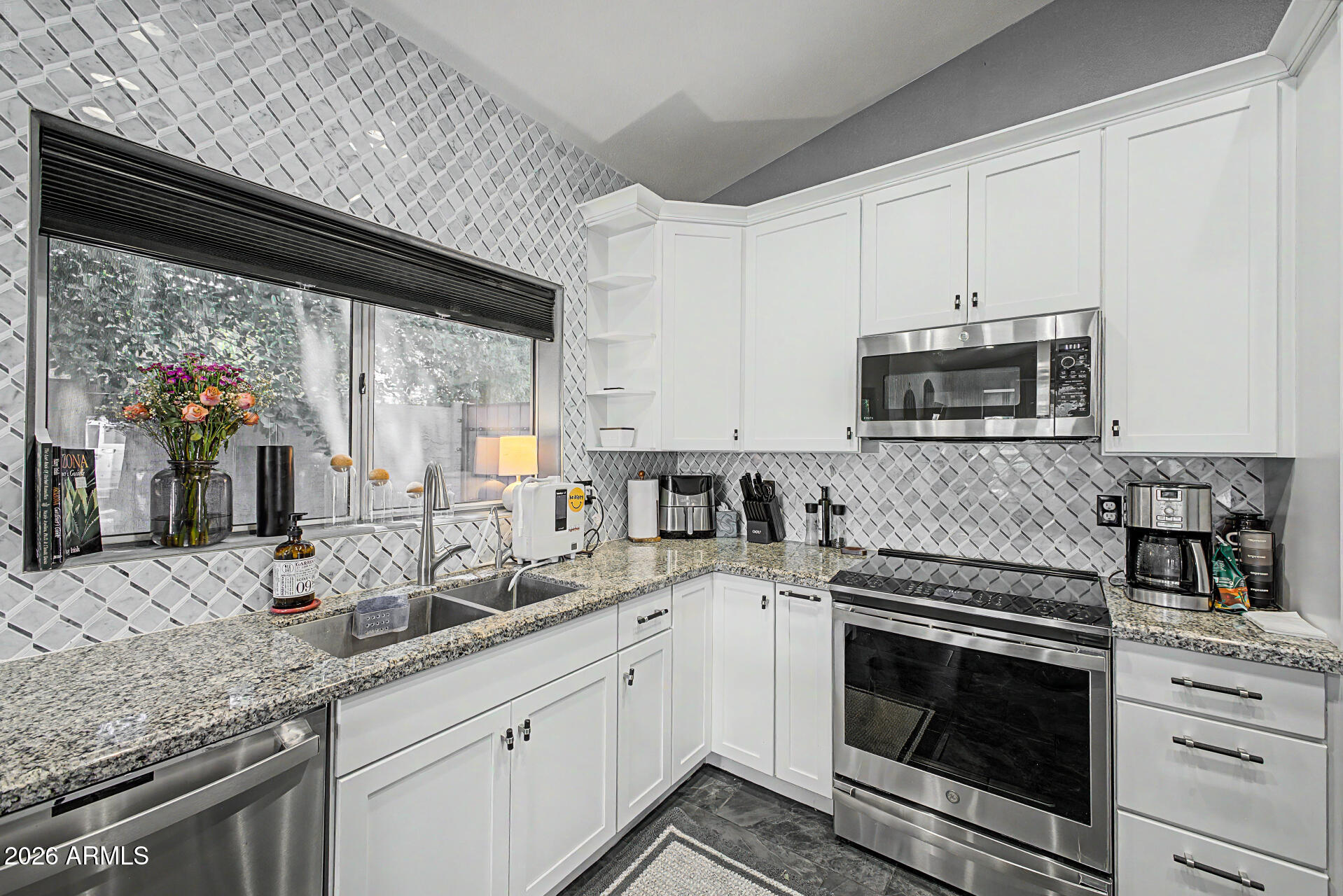Beautiful 3-bedroom home w/ paid solar is looking for its new homeowners! Featuring a 2-car garage w MyQ app, RV gate, and mature landscaping. Fall in love with the perfectly flowing living & dining room along with the desirable great room filled with bountiful natural light. Tall vaulted ceilings add to the spacious feel, enhanced by tile flooring, ceiling fans, archways, and custom paint. Fabulous kitchen includes blue-tooth enabled stainless steel appliances, induction stovetop, ample cabinetry, tile backsplash, a pantry, recessed lighting, granite counters, and a center island with a breakfast bar. Airy main bedroom offers outdoor access, a walk-in closet, and an ensuite with an enclosed glass shower. Large backyard provides a relaxing outdoor escape, complete with a covered patio.