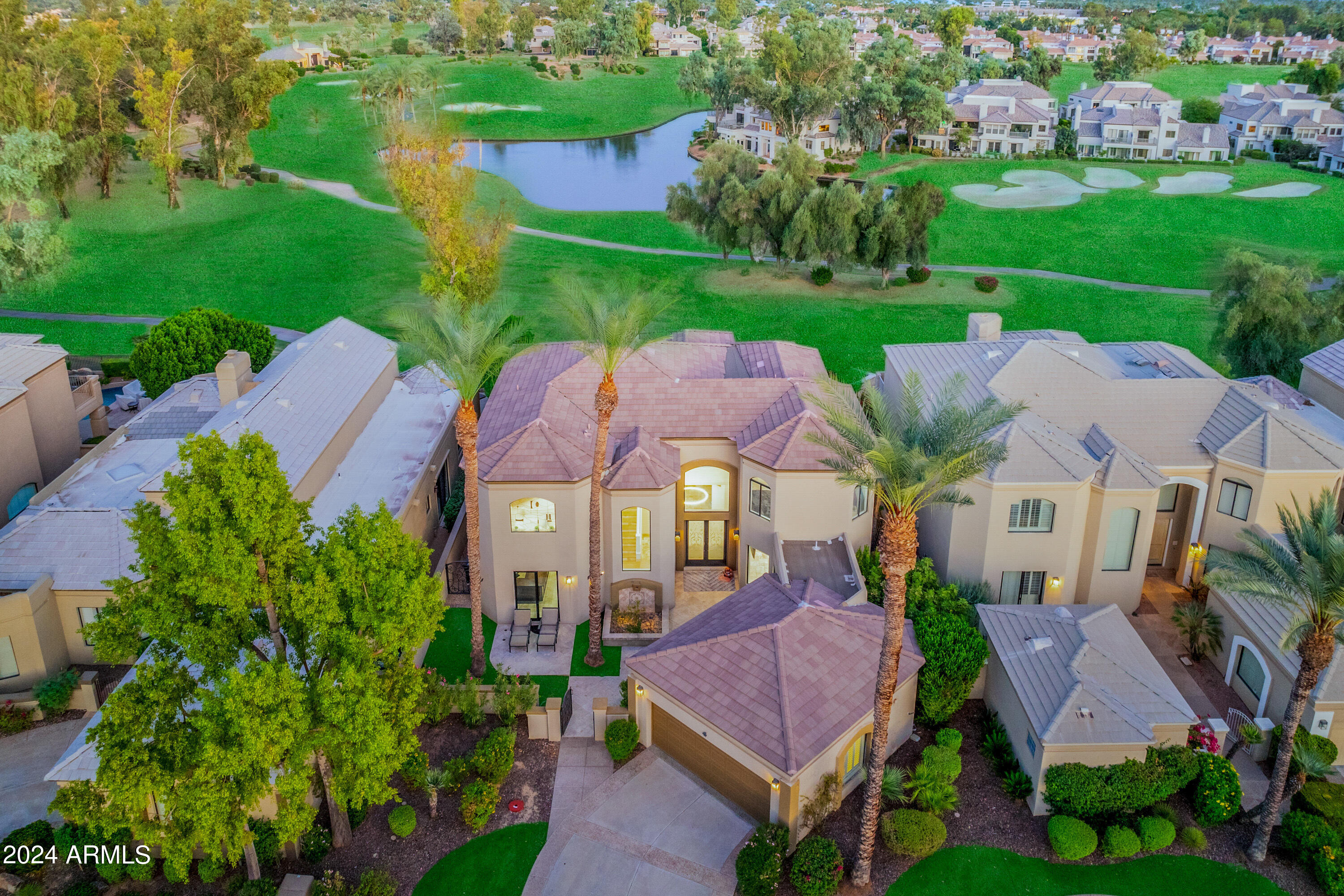 RARE TOTALLY REMODELED HOME in Enclave #2, with unparalleled  views of the Lakes #5 golf course, overlooking water, mountains, and with additional expansive views of the golf course on holes 2, 3 and 4. No expense was spared in this totally remodeled modern chef's kitchen with Waterfall Quartzite countertops, WOLF gas stove and center wok burner (propane), TWO Subzero Fridges with freezer drawers, and cabinetry from Plain and Fancy. This great entertaining 4 bedroom 3.5 bath home offers a quality paneled Library/bedroom on the main level with full bath, a great room with wet bar, and private media room. New windows and slider doors. Lutron electric window blinds throughout. The main rooms open to a fabulous backyard with pool and waterfalls, firepit, with spectacular golf course views. Enjoy all the amenities Gainey ranch has to offer. New ''state of the art'' Gainey Ranch Estate club with everything from tennis and pickle ball to a spacious work out facility. Close to shopping at the Gainey Village and walking to the Hyatt Hotel!