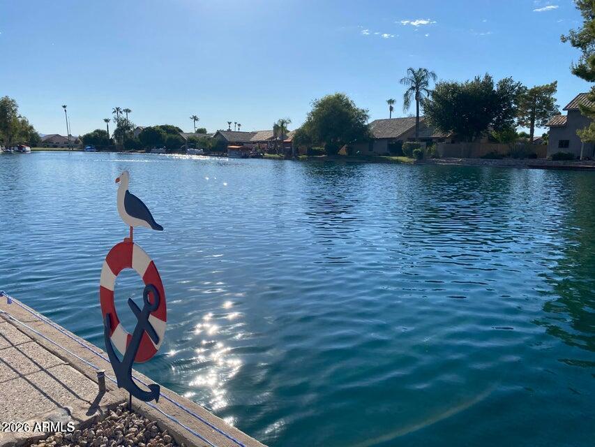Beautiful single level waterfront property in Harbor Island.  Gorgeous lake views make this home simply one of a kind, providing peach and quiet.  The boat slip is just icing on the cake.  Move in ready  home with granite countertops in the kitchen and newer stainless steel kitchen appliances.  Refrigerator, washer and dryer are provided.  Great room concept with two bedrooms which are split from one another and then there is a third bedroom (does have a closet), easily utilized as an office or den with double door entry, just off the family room.  Large maser suite with lake views and separate patio access to back.  Great gated community with  pool and spa within walking distance of this home.  You will not be disappointed.  Tenants to verify all schools.