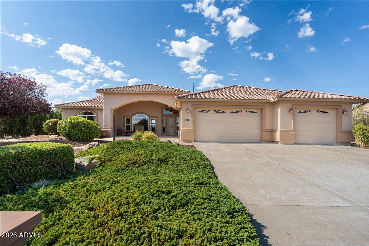 This beautifully maintained single-level Pinon Oaks home offers the convenience of a level driveway, easy year-round access, lovely views and outdoor enjoyment. A welcoming flagstone-covered front porch sets the tone for relaxed mountain living. Step inside to a spacious open-concept great room featuring soaring ceilings, abundant natural light, a cozy stone fireplace, a separate sitting area, and nice views from nearly every window. The thoughtful floor plan creates an ideal setting for both entertaining and everyday living. The nice sized kitchen offers extensive counter space, abundant cabinetry, and plenty of room for gathering with family and friends. The spacious primary suite serves as a private retreat, complete with a spa-inspired bathroom featuring a separate soaking tub and shower, elegant glass block accents that provide natural light while maintaining privacy, and generous space to unwind. Two additional bedrooms, a full guest bath, and a well-sized laundry room provide comfort and functionality for family, guests, or a home office setup. Step outside to enjoy the best of Arizona's four-season lifestyle. The backyard features a large covered patio, low-maintenance landscaping, mature trees and plantings, and a charming flagstone conversation area perfect for morning coffee, evening gatherings, or stargazing under cool mountain skies. Ideally located for those seeking a second home, summer getaway, or full-time residence, this property offers the cooler temperatures, fresh mountain air, and peaceful setting. Enjoy nearby hiking, outdoor recreation, wildlife viewing, and the relaxed lifestyle that makes Northern Arizona one of the state's most sought-after destinations.
