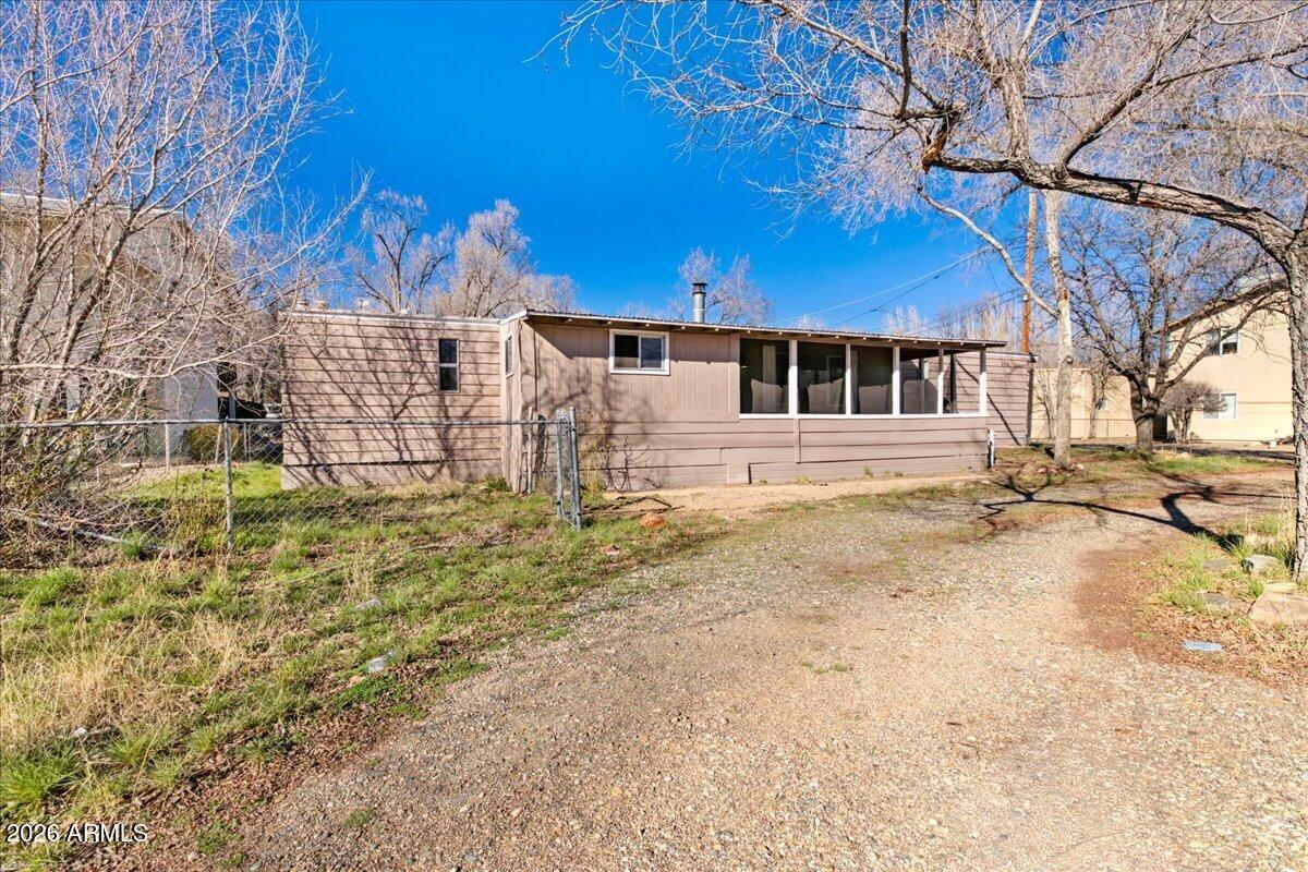 Just minutes from the vibrant heart of downtown, this well-maintained manufactured home offers a rare blend of comfort, convenience, and investment potential on a spacious multi-family zoned homesite. The property welcomes you with a charming front exterior that provides ample parking, including space for an RV, along with plenty of room to accommodate a variety of lifestyles or investment needs.
Inside, the home opens to a generously sized living room that serves as the central gathering space of the home. A cozy wood-burning stove adds warmth and character. The living area flows easily into the kitchen, where you'll find a stainless-steel range and abundant cabinetry, providing functionality and ample storage for everyday living.
The primary bedroom offers a comfortable & private retre The primary bedroom offers a comfortable and private retreat, complete with its own ensuite bathroom designed for convenience and relaxation at the end of the day. Three additional bedrooms provide excellent flexibility, whether used for family members, guests, a home office, or hobby space. A second full bathroom is thoughtfully positioned to serve these rooms. Throughout the home, a combination of carpet and durable vinyl flooring provides comfort underfoot while maintaining easy, low-maintenance care.
Outside, the backyard extends the home's living space with a patio that is perfect for enjoying fresh air, outdoor dining, or quiet mornings. A separate storage room adds practical functionality, while a dedicated dog run provides a safe and secure space for pets. The generous yard space, combined with the valuable multi-family zoning, creates the potential to add another unit and maximize income possibilities.
With a previous rental history producing an impressive 8% cap rate, this property presents a strong opportunity for investors while still offering comfortable living for an owner-occupant. Seller financing is available with $100,000 down, and additional lending options may also be available, making this a versatile opportunity for buyers looking to secure a property with both lifestyle and income potential.