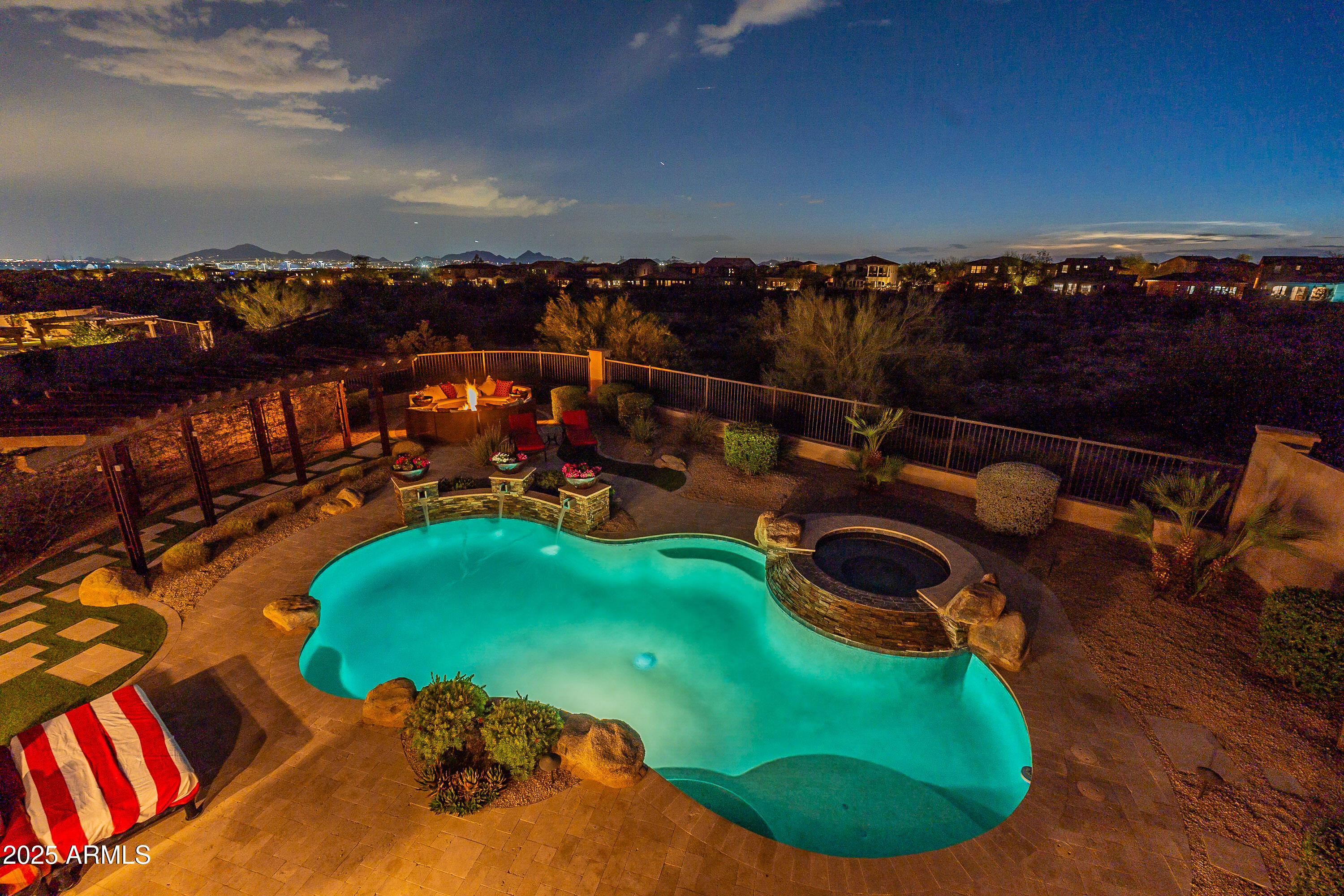 PRIVACY AND VIEWS in Guard Gated Windgate Ranch.Set on a premium, private lot backing to the protected NAOS preserve, this stunning estate delivers both panoramic city and mountain views and an incredibly upgraded living experience. Boasting 6 bedrooms, 5.5 bathrooms including a and an air-conditioned 3-car garage this home has been meticulously Remodeled and Updated with High-End Luxury Finishes throughout. A dramatic entryway sets the tone for the Open Space FloorPlan dressed in Brand New European 9'' Real Wide-Plank White Oak Hardwood Flooring throughout, upgraded lighting, and soaring 12'+ ceilings. The Gourmet Kitchen features stainless-steel appliances, 6-burner gas cooktop and hooded gas range, thick granite slab counters, over-sized custom island, and a separate breakfast bar island. The Great room with a retractable glass wall showcases the stunning outdoor living patio's seating and dining areas, sparkling water features, heated pool, hot tub, and built in gas firepit. This is the perfect entertainer's haven or relaxing owner's retreat. 

Additional upscale features: Private upstairs balcony outdoor living space, Kohler fixtures, exquisite main level master suite includes a lavish 7' jetted tub, 10 ft. solid core doors, electric interior and exterior shades, plantation shutters, iron & wood stair banister, epoxy garage floors. 

Community amenities: Resort style living on nearly 6 acres of green space throughout, Clubhouse, Member's Club, Teen Center (game tables, microwave & refrigerator), walking trails, playgrounds, picnic ramadas, tennis, pickleball, basketball courts, beach volleyball, 3 year-round heated pools & spas, poolside cabanas, open-air living room. McDowell Sonoran Preserve Gateway Trail is across from community. Less than 5 minutes from golf, shopping, dining, and entertainment venues. Half mile from loop 101 for easy access to downtown Scottsdale and Phoenix.