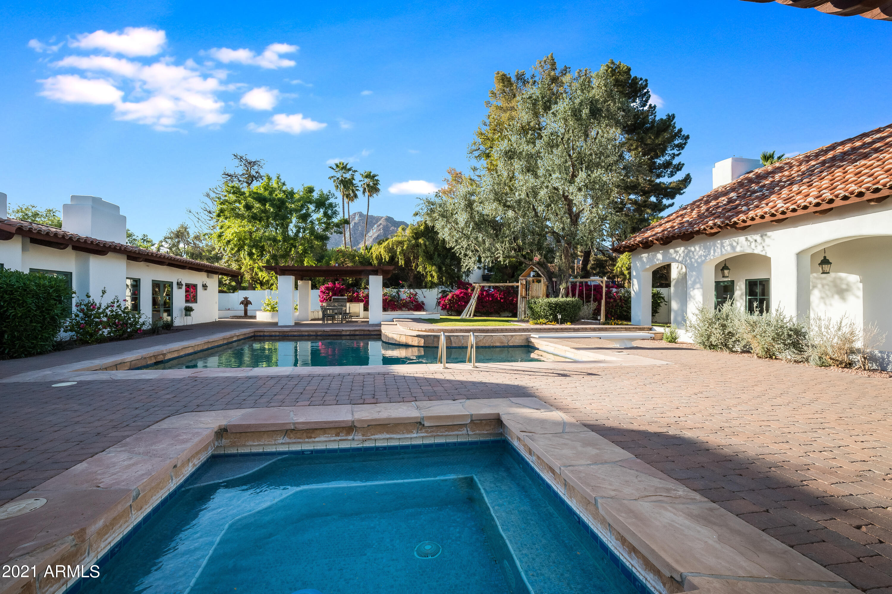 One of a kind Spanish Hacienda located north of Exeter in the sweet spot of Arcadia Proper. This charming estate-like property is on nearly an acre of land and is a perfect for the discriminating buyer who wants something truly special. The 4200' main house has soaring wood beamed ceilings and authentic herringbone Mexican tile floors throughout. Walls of windows provide views from all rooms to the property's courtyards, pool, spa, gazebo, fire pit and Camelback Mountain. The two living areas and master suite are all anchored by cozy fireplaces. The kitchen and butler's pantry are off the charts with newer appliances, quartz/wood counters, Tabarka tile backsplash, a huge island and loads of natural light. Floorplans in the documents tab-  see more Incredible master suite with sumptuous bath and his/hers closets. The back yard is an entertainer's dream. It's also home to the enchanting 1000' casita which was recently renovated. The kitchen has newer contemporary cabinets, quartz counters, Tabarka backsplash and stainless appliances. Large living area with a floor to ceiling fireplace and bath. Windows and french doors provide access to pool and sport/pickle ball court. Newly built custom staircase to the upstairs bedroom makes this an incredible place for friends and family to hang out and enjoy the Arcadia Lifestyle!