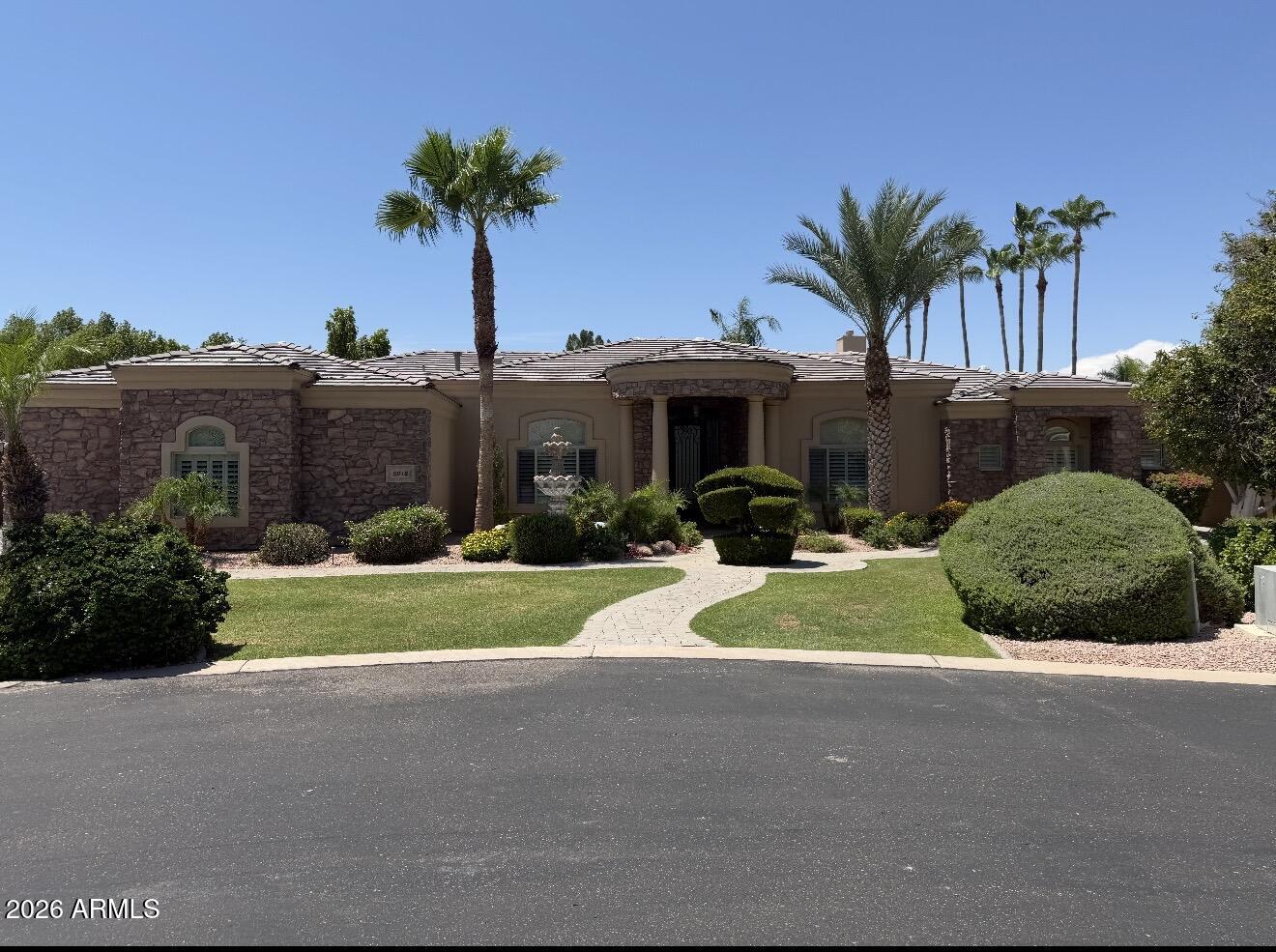 Nestled on a premium cul-de-sac lot in the gated Vista Estancia community, this custom estate offers luxury, privacy, and incredible garage space. Featuring 4 bedrooms, 3.5 bathrooms, and over 4,100 sq ft, the thoughtfully designed floor plan showcases soaring ceilings, travertine flooring, Cantera stone accents, and multiple fireplaces. The chef's kitchen includes granite countertops, a large island, breakfast bar, stainless steel appliances, abundant cabinetry, and a walk-in pantry. The spacious primary suite features a sitting area, fireplace, patio access, and spa-like bath. Enjoy Arizona living in the resort-style backyard with a sparkling pool, built-in BBQ, covered patio, and lush landscaping. An attached and detached garage provide space for up to 8 vehicles, toys, or a workshop.