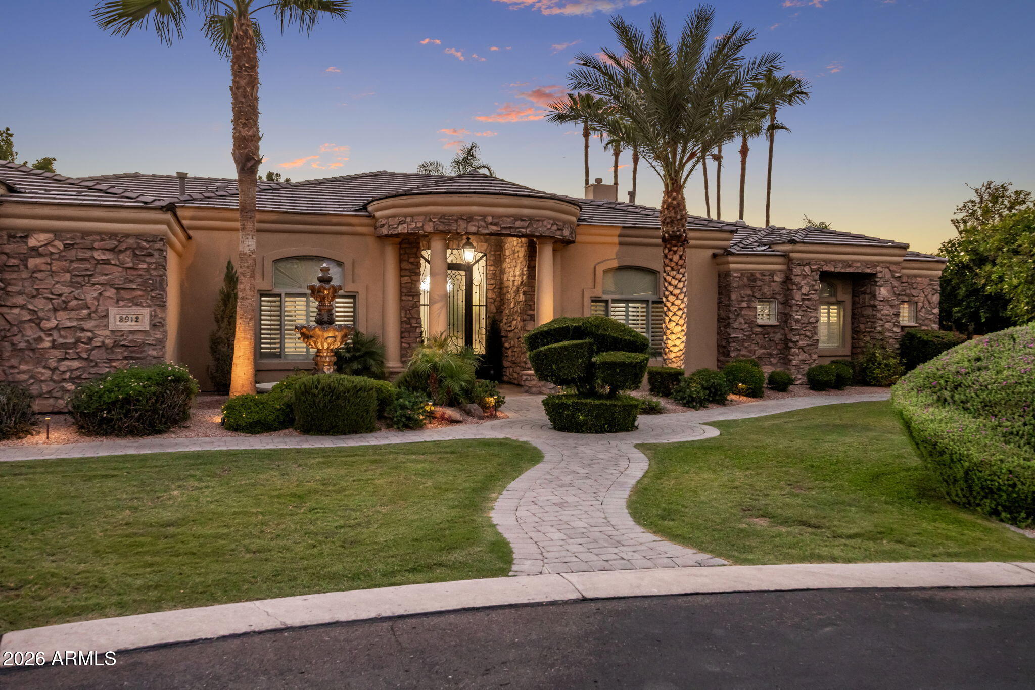 Nestled on a premium cul-de-sac lot in the gated Vista Estancia community, this custom estate offers luxury, privacy, and incredible garage space. Featuring 4 bedrooms, 3.5 bathrooms, and over 4,100 sq ft, the thoughtfully designed floor plan showcases soaring ceilings, travertine flooring, Cantera stone accents, and multiple fireplaces. The chef's kitchen includes granite countertops, a large island, breakfast bar, stainless steel appliances, abundant cabinetry, and a walk-in pantry. The spacious primary suite features a sitting area, fireplace, patio access, and spa-like bath. Enjoy Arizona living in the resort-style backyard with a sparkling pool, built-in BBQ, covered patio, and lush landscaping. An attached and detached garage provide space for up to 8 vehicles, toys, or a workshop.