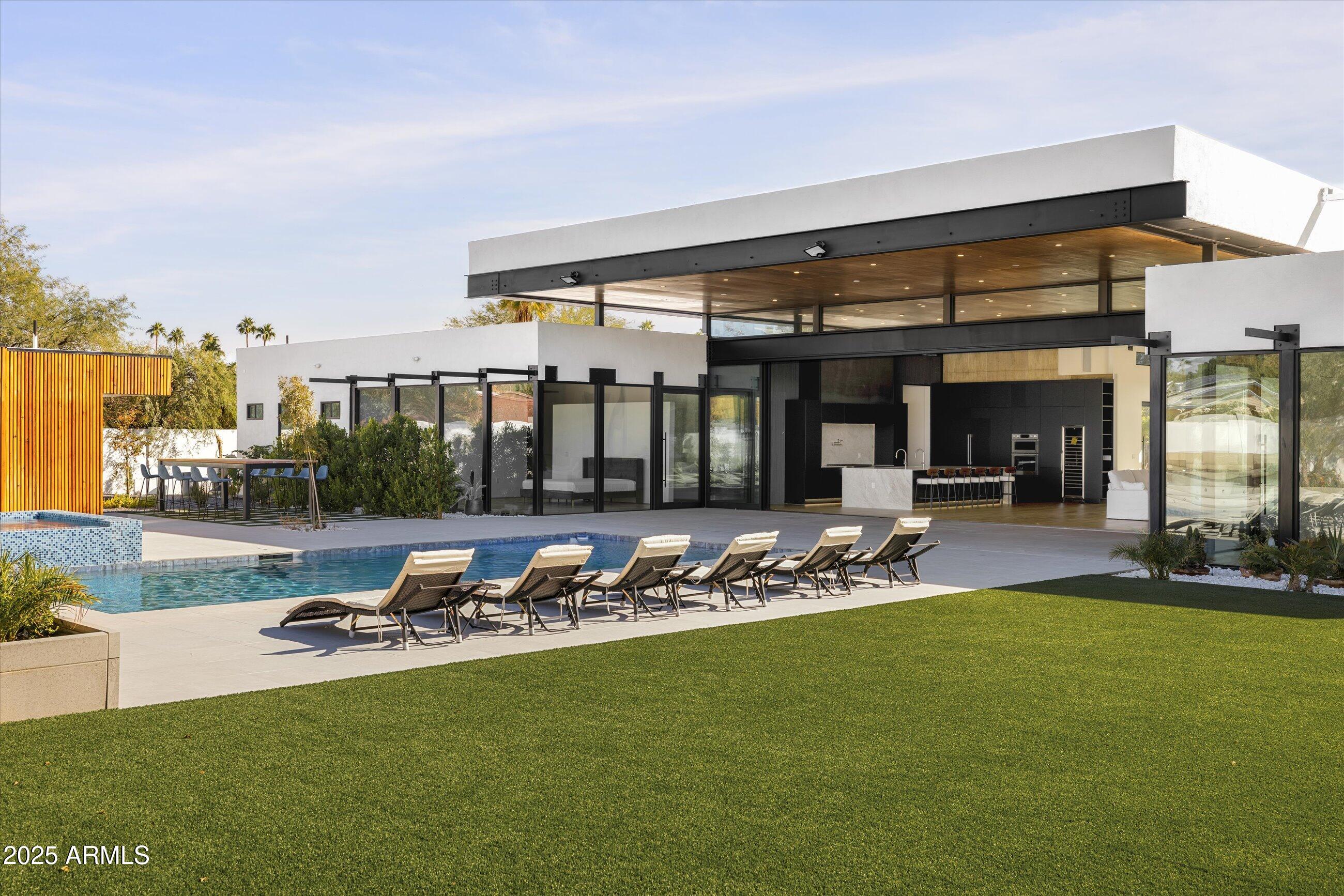 *Just Completed* Stunning 5569 sqft Architecturally Significant Contemporary home on over half-acre lot in 85254. Steel Components, soaring ceilings, open spaces and beautiful finishes abound.  Home boasts a true designer kitchen with a fully functional back kitchen.  The exterior is highlighted by the visually striking pool and elevated hot tub, fire pit and incredible outdoor kitchen with its own bathroom. 5 expansive bedrooms with a flexible floorplan. Air conditioned garage and automated side gate.