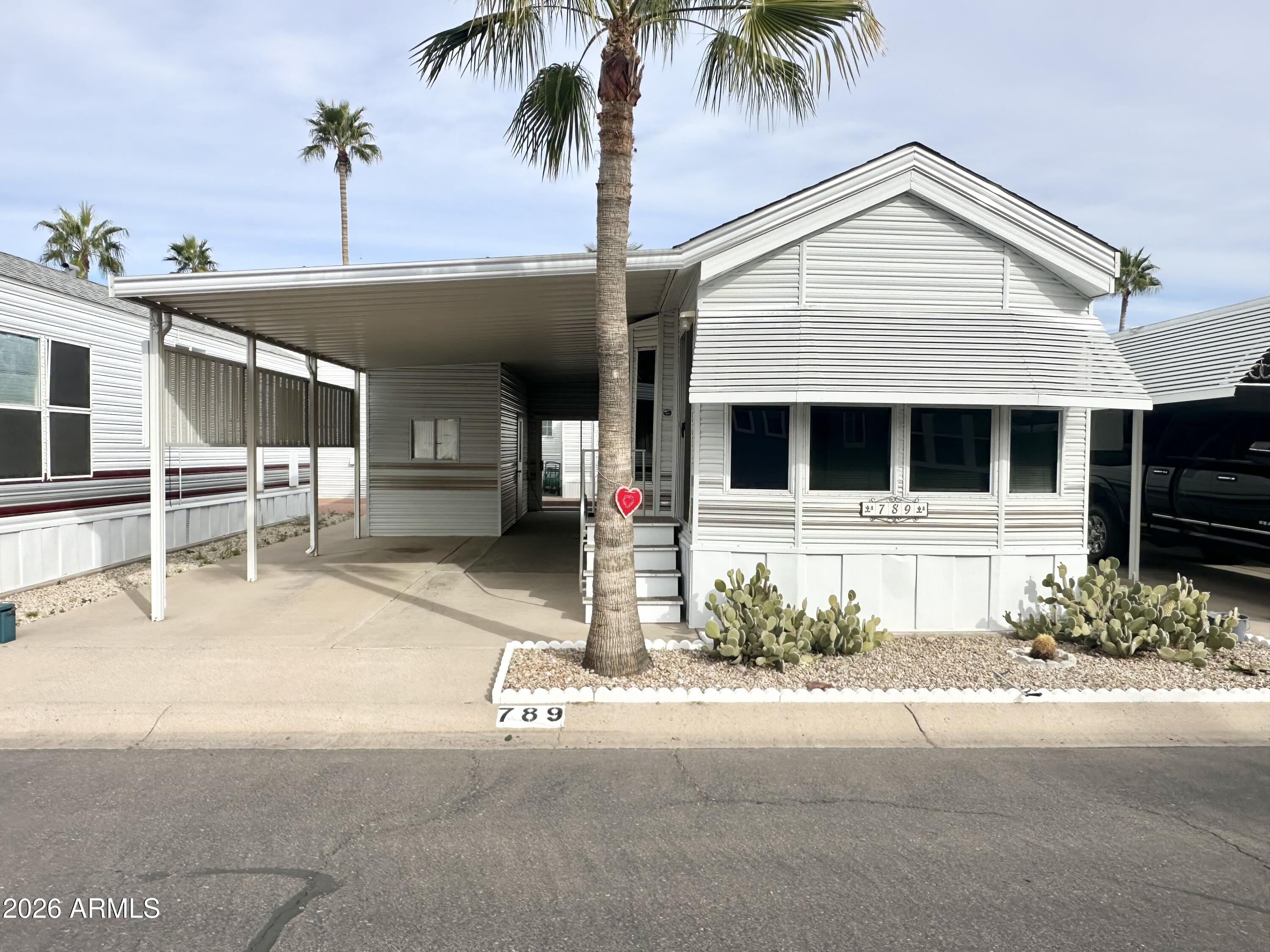 Welcome to this WELL CARED for 1995 Cavco park model located in a WONDERFUL 55+RESORT filled with activities, pools, and nonstop fun! This SOUTH facing home sits in a GREAT LOCATION, conveniently close to the Clubhouse, making it easy to enjoy everything the community has to offer. This CLEAN AND WELL LOVED home features 1 bed, 1 bath with a NICE OPEN AND INVITING FLOOR PLAN with neutral colors throughout. The kitchen offers a nice layout with decent counter space for cooking and plenty of cabinets- storage will never be an issue here! The roomy bedroom comfortably fits a QUEEN SIZE BED and includes a BUILT IN DRESSER, MIRRORED CLOSET and lots of storage. The bathroom features a TUB/SHOWER COMBO, a nice vanity and additional storage space and roomy for dressing. Enjoy the front living area that is open, bright and perfect for entertaining or hosting visiting guests. You will love the wrap around cabinets great for storage. Easy to clean flooring in kitchen & bathroom area adding maintenance appeal. Outside, you'll find a SPACIOUS CARPORT with PLENTY of room for parking, plus a roomy SHED that offers even more storage. The back patio provides space for your bbq and a fifth wall with a sliding glass door that creates privacy and a COMFORTABLE additional OUTDOOR LIVING AND GATHERING AREA. MAJOR updates includes a recently replaced furnace motor and a BRAND NEW ROOF installed in 2018-offering GREAT PEACE OF MIND. CLEAN, MOVE IN READY AND THOUGHTFULLY MAINTAINED & FURNISHED, this home is ready for its next owner to start enjoying the resort lifestyle.  OWN THE LAND..OWN THE FUN! THIS IS A MUST SEE HOME!