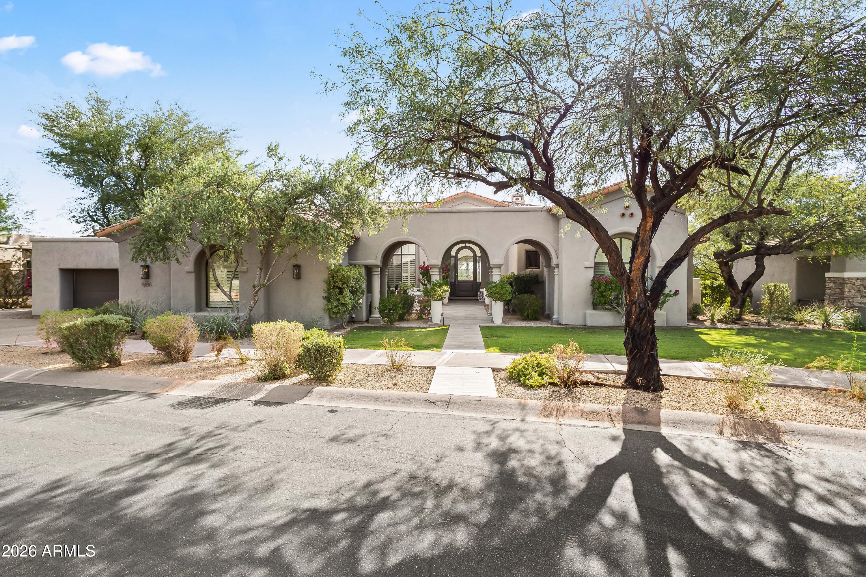 Nestled in the prestigious guard-gated community of DC Ranch, this stunning single-level home offers the perfect blend of luxury and comfort. Enjoy breathtaking sunsets from your resort-style backyard featuring a custom heated pool and spa with water feature, multiple areas to dine and entertain, built-in BBQ station, covered patio with misting system and heaters, plus a ramada with gas fireplace. Inside, an open-concept floor plan showcases a great room with fireplace, built-ins, and French doors to the backyard. The chef's kitchen includes two islands, high end appliances, multiple ovens, wine fridge, sunny breakfast nook, and adjoining family room with fireplace and custom cabinetry. Retreat to the primary suite with sitting area, spa-like bath, freestanding tub, oversized shower, dual vanities, and custom walk-in closet. Located just steps from DC Ranch Country Club, Market Street's dining and shops, and miles of scenic hiking and biking trails, this home places North Scottsdale's finest amenities at your doorstep. Residents also enjoy easy access to world-class golf, top-rated schools, and vibrant community events.
