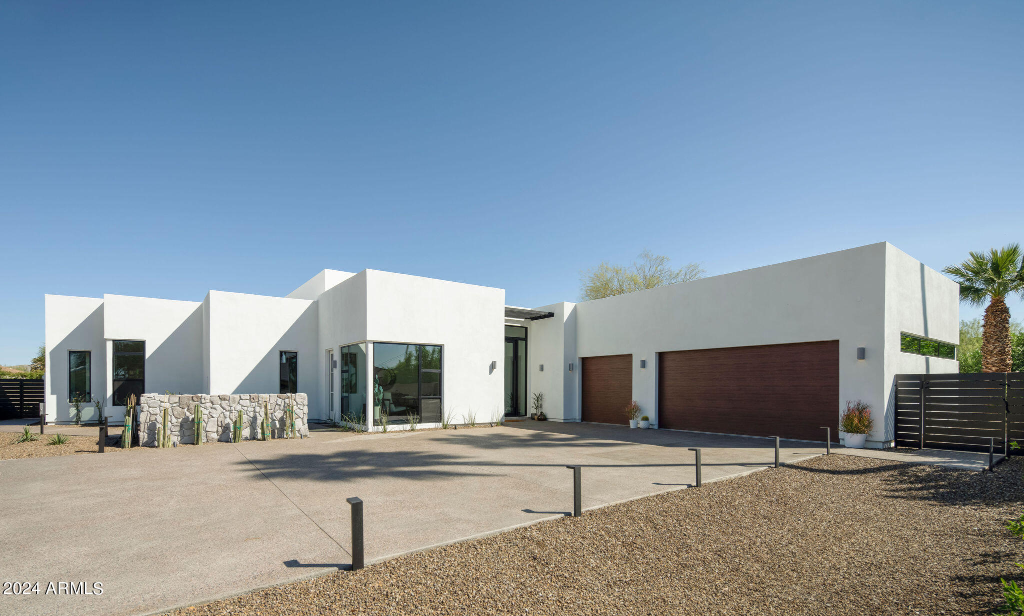 Step into modern luxury in Paradise Valley, just moments away from the vibrant energy of Old Town Scottsdale. Completed with meticulous attention to detail, this home is a masterpiece designed by Joel Contreras. Situated on a lush half-acre lot, this sprawling 4,000-square-foot residence offers four spacious bedrooms, each with its own lavish en-suite bathroom, alongside a powder room for guests, dedicated office, walk-in wine cellar, and private outdoor seating off the owner's en-suite. Inside, an open-concept layout seamlessly merges the living, dining, and kitchen spaces, adorned with top-of-the-line finishes Thermador appliances. The great room effortlessly extends to the outdoor living space, creating the perfect atmosphere for hosting guests or enjoying leisurely moments in style. Step outside to discover the meticulously curated landscape, harmonizing with the home's modern design. A stunning pool and spa with two fire pits serves as the focal point of the outdoor area, inviting you to bask in Arizona's abundant sunshine and views of Camelback mountain. Nestled in the heart of Paradise Valley, this home provides easy access to top schools, fine dining, and upscale shopping, striking the perfect balance between suburban tranquility and urban convenience. Don't miss this rare opportunity to own a completed masterpiece in one of Arizona's most coveted communities.