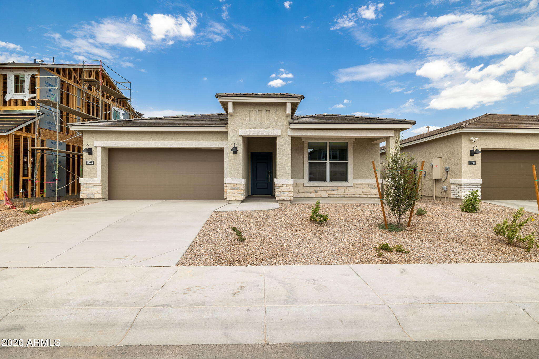 This beautifully upgraded home features a bright, open floor plan designed for modern living. The kitchen showcases warm burlap shaker cabinets, quartz countertops, a classic subway tile backsplash, & upgraded stainless steel appliances including range, oven, dishwasher & microwave. Under cabinet lighting adds both ambiance & functionality. Throughout the main living areas, enjoy durable 12x24 inch block lay  tile, while upgraded carpet provides comfort in the bedrooms. Elegant 8 ft interior doors enhance the sense of space & style. A sliding glass door opens to the patio, seamlessly blending indoor & outdoor living, perfect for entertaining or relaxing at home. Pictures may represent other model homes.  July Completion