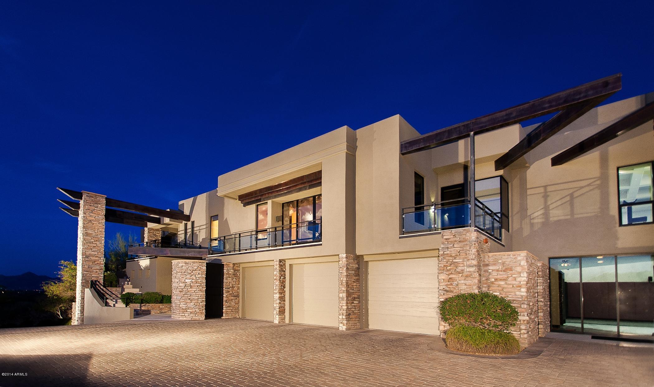 *STUNNING CONTEMPORARY, SWEEPING VIEWS* Artfully designed to capture floor to ceiling mountain views of Camelback, Mcdowell, and Sunset Hills at every turn. An entertaining delight! Sports enthusiasts will love the indoor basketball court w/retractable batting cage, and restaurant style sideline booths w/ adjoining theatre room, stylish bar and theatre recliners perfect to watch the big game or the latest blockbuster.Splash in the gorgeous resort style desert springs pool w/two wateralls, jacuzzi, elevated sundeck and built-in grilling station. Honed limestone flooring lead to the Chef's kitchen featuring state of the art appliances, sumptuous cherry wood cabintery w/ designer under cabinet lighting and black granite & glass countertops. State of the art amentities of the finest luxury hom