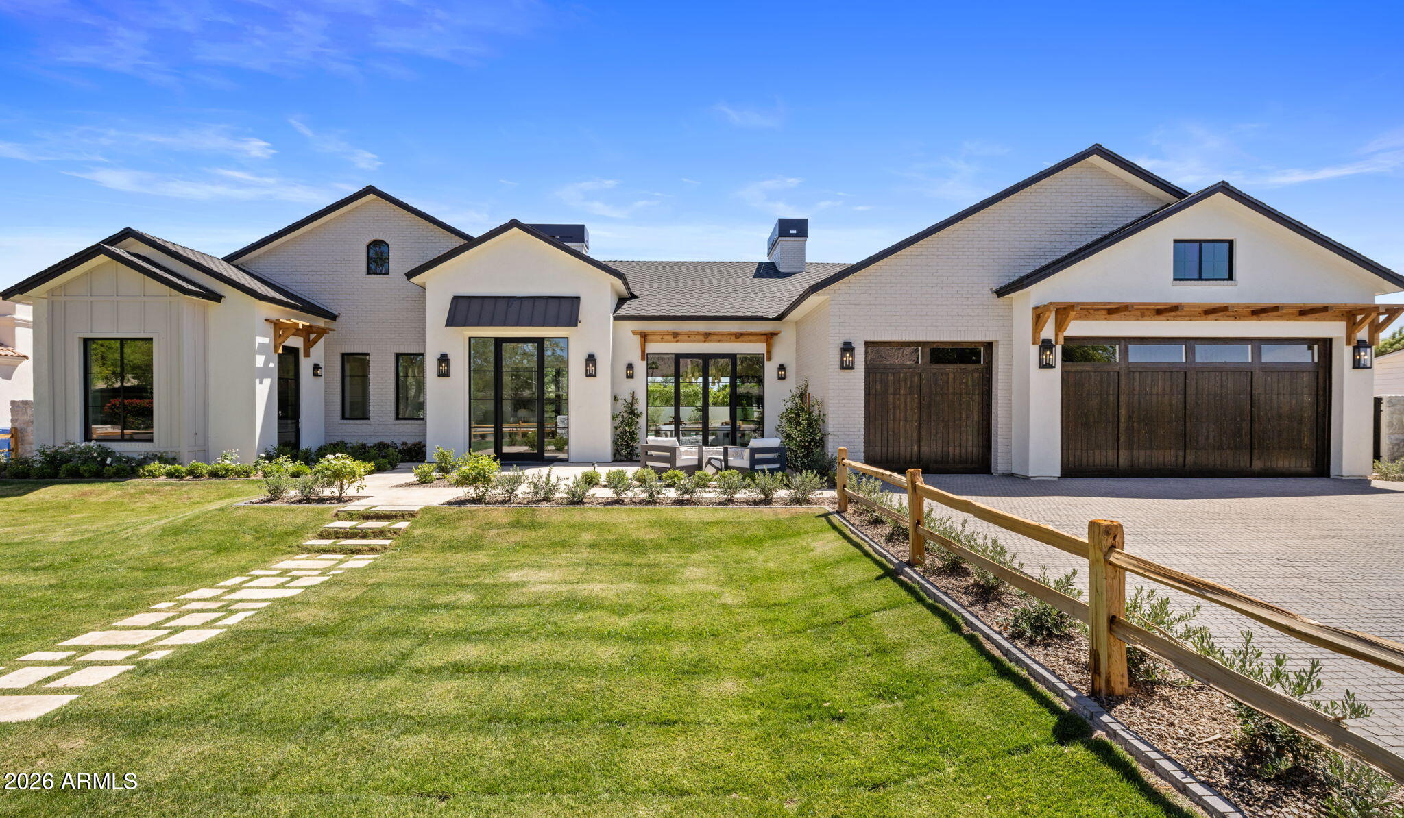 In Arcadia, there's a certain kind of street where the pace feels slower, the trees feel taller, and coming home actually feels like arriving. This new BINK Development residence was built for that feeling--clean, timeless architecture from the outside, and a warm, intentional sense of luxury once you step through the door. Inside, the home unfolds with purpose--spaces that feel distinct, yet effortlessly connected. The heart of the home is an open-concept kitchen and great room that invites long dinners, easy mornings, and gatherings that don't need a special occasion. Just off the entry, a private home office offers a quiet place to focus. The main level is anchored by a spacious primary suite with spa-like amenities, plus a walk-in closet with its own laundry. Two additional en-suite bedrooms and a three-car garage round out the floor plan with comfort and functionality. Downstairs, natural light pours in through a glass-encased staircase and oversized slider that opens to an additional patio--creating a lower level that feels bright, open, and truly livable. The basement includes a fourth bedroom and a generous game room with a full bar and seating for your closest friends. The perfect spot for entertaining, relaxing, or hosting guests. Step outside and the lifestyle becomes the headline: a fully landscaped property with a true backyard of dreams--a covered patio with a full outdoor kitchen, a resort-style pool and spa, and a sunken seating area with a fire pit that turns evenings into an experience. This is the kind of home where you host without trying, where quiet nights feel special, and where everyday routines start to feel like the dream you thought you had to travel for. A new build in Arcadia Proper with a backyard that delivers--rare, real, and ready.