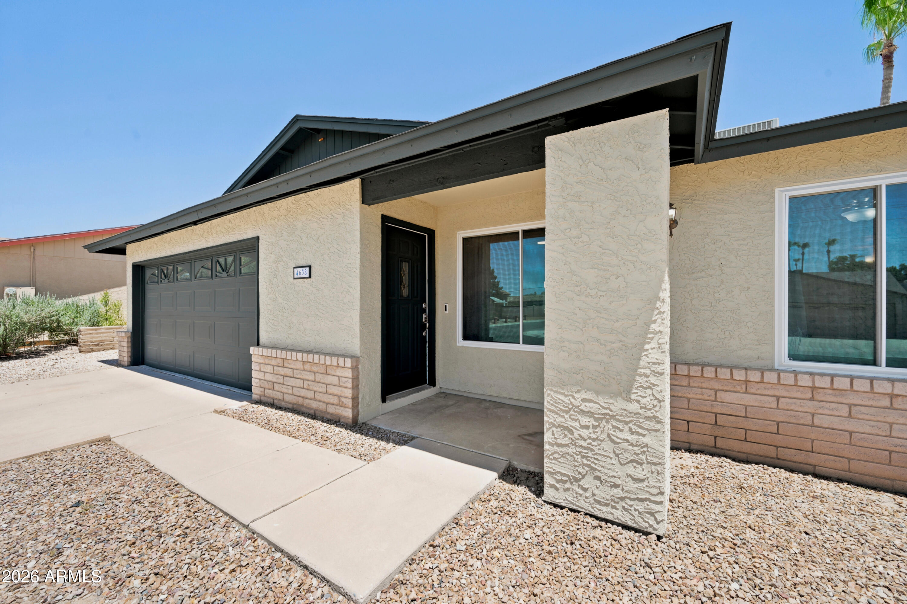 Welcome to this beautifully updated Ahwatukee home tucked away in a desirable double cul-de-sac location with no HOA! Offering 3 bedrooms, 2 bathrooms, and over 1,800 square feet of thoughtfully designed living space, this home combines modern upgrades with timeless charm.
Step inside to soaring vaulted ceilings, luxury vinyl plank flooring throughout, and an open-concept floor plan perfect for everyday living and entertaining. The inviting family room features a cozy wood-burning fireplace, creating the perfect gathering space. The kitchen is the heart of the home, showcasing a large quartz-topped island with soft-close grey cabinetry, while the rest of the kitchen features white cabinets with granite countertops, glass-front display cabinets, oversized drawer storage, and stainless steel appliances.The spacious primary suite offers direct backyard access, a huge walk-in closet, and an updated bathroom with a subway tile shower surround. Ceiling fans throughout the home provide added comfort, while major upgrades offer peace of mind, including new windows (2022), AC system (2021), brand-new roof (2025), and fresh exterior paint (2026).Enjoy Arizona living year-round in your private backyard oasis complete with a diving pool and spa. Additional features include a 2-car garage and a highly sought-after location in a quiet neighborhood with no HOA.This move-in-ready home perfectly blends modern updates, and exceptional indoor-outdoor living.