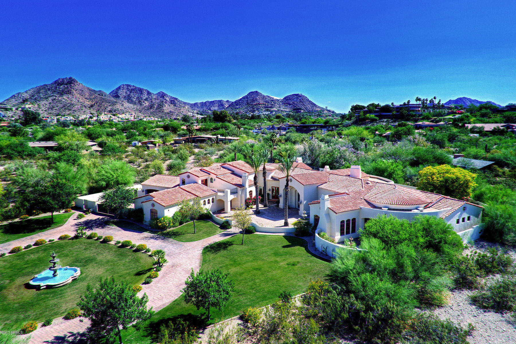 An exquisite Santa Barbara style home with tasteful and timeless elegance situated on 1.18 acres in the heart of Paradise Valley. This meticulously built 5 bedroom/7 bath, 9,005 square foot estate showcases stunning custom craftsmanship featuring a grand foyer, marble/wood flooring, formal living/dining rooms, library, media/game room, wine cellar, separate tasting room and an over sized chef's kitchen open to the great room. The romantic master suite boasts a sitting area, fireplace and an intimate covered patio an fountain. Walls of French doors open to multiple covered patios with mountain views. An outdoor kitchen with misters, sparkling pool and spa offer the perfect setting for entertaining. A 6 car garage with gated motor court complete this incredible home.