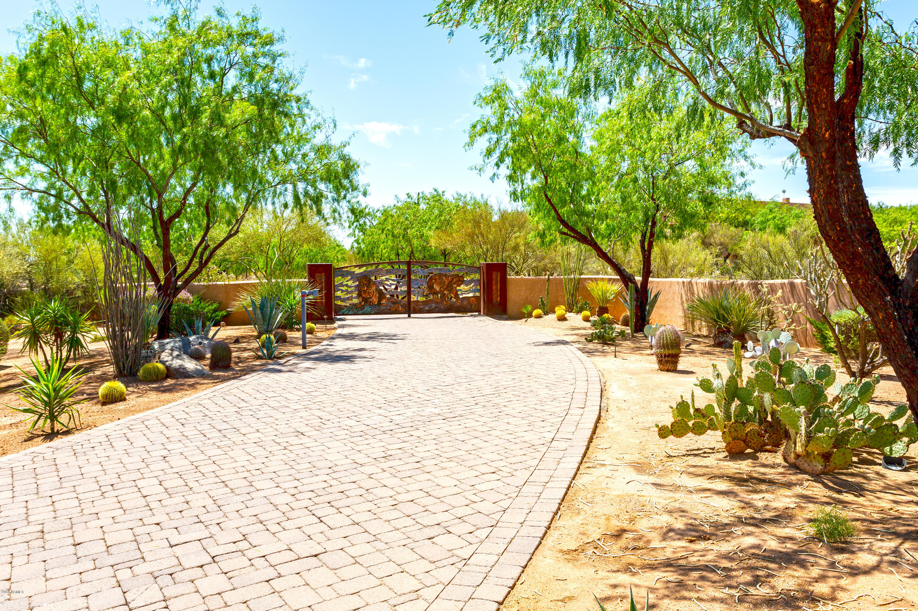 No expense spared on this gated Desert Oasis Compound on 15.5 acres. One of a kind museum quality gallery style home with lush resort grounds. Main house includes 25'ceilings, 3 bedrooms, 5 baths, game room, and wine cellar. Additionally there is a guest house, office with full bath, and a wood shop or conservatory. Master bedroom wing includes exercise rm, sauna, two large closet rooms, and private covered patio. Also home has 800+ gallon saltwater aquarium in foyer, art gallery, Chestnut plank floors, limestone counters thru-out, and Venetian plaster walls. Four car oversized garage, with powder room, adjacent to 3 large outdoor kennels or stalls. Approximately one acre of a small scale railroad with elaborate tracks, trains, train barn, small scale cities, bridges, and viewing decks.