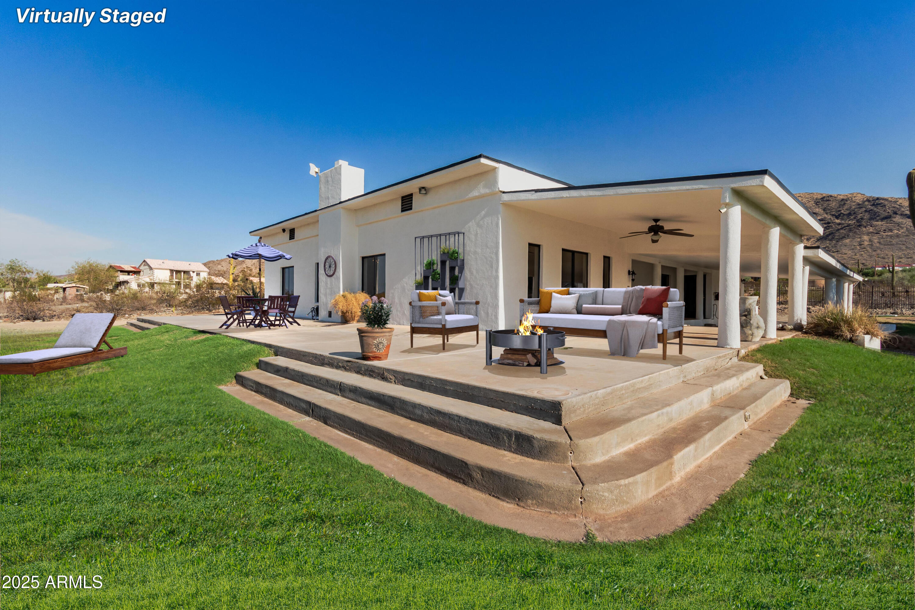NO HOA AND VIEWS GALORE!!!  This stunning 4-bed, 3-bath home in Laveen offers 3,068 SF of elegant living space on 1.364 acres, w/ breathtaking views of the mountains, desert, & city lights. This home features a spacious newly remodeled kitchen w/ quartz waterfall center island, cozy fireplace in great room & soaring nine-foot flat ceilings that enhance the open & airy feel. Enjoy outdoor living at its finest on the spacious patios, while custom gated entries bring you to two circular driveways. Outdoor 6 irrigated zones for lush natural grass w/ entire fenced yard offering space for domestic pets. Dedicated dog run w/ JGR dog door.  Potential for horses, garage/workshop, RV parking, vehicle storage. Rental possibility for 3rd bedroom w/ separate entrance & bath. Improvement list - doc tab Amazing sunsets! Freedom to make this desert retreat truly your own. Rural charm w/ suburban convenience and miles of scenic trails.  Thoughtfully updated throughout, this home includes custom lighting in the great room & large format tiles in key areas.
