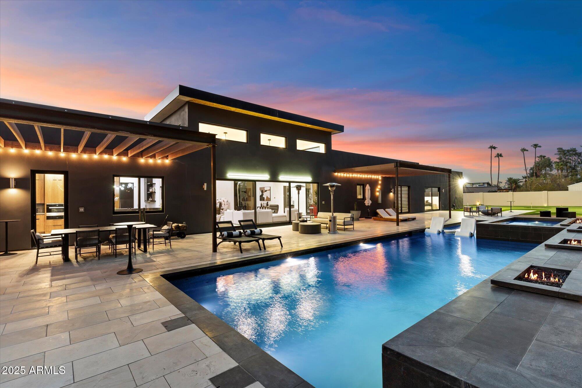 *OWNER MAY CARRY OR DO LEASE PURCHASE! Gorgeous newly built Desert Contemporary located in the Cactus/Shea Corridor. This single-level masterpiece blends modern elegance with thoughtful design. Featuring 5 beds/5 baths + 2 half baths, an open-concept great room, resort-style backyard, & an expansive 3-car garage w/ custom cabinetry. A serene water feature sets the tone as you arrive. Passing through the pivoting glass front door, you'll be greeted by abundant natural light & soaring 20-ft ceilings, leading you into the great room. The kitchen is a showstopper w/ an oversized island w/ Dekton Constantino quartz, Miele appliances, & custom maple cabinetry set the stage for culinary excellence. The 3-Panel glass slider seamlessly connects indoor and outdoor living, ideal for entertaining! Additional enhancements include custom Roman clay wall finishes throughout the main living space.

The Primary Suite is a private retreat with a cozy fireplace, beautiful wall coverings, a sitting area, and a spa-like bath featuring a copper Japanese soaking tub, a dual-head walk-in shower, and 2 custom-designed walk-in closets.
Two additional bedrooms in the primary wing, each with en-suite baths and stunning black hardwood floors, offer privacy and serenity for family and guests.
A thoughtfully designed laundry room with a half bath and direct outdoor access makes poolside living effortless.
The fourth bedroom is set apart in its private wing. It is expansive in size and boasts an ensuite bathroom, a generous walk-in closet, and both exterior and direct access to the home.
The Ultimate Guest ExperienceA private poolside casita provides an additional retreat, complete with a bedroom and living area, custom cabinetry, quartz countertops, a microwave/convection oven, and a luxury bath. It is ideal for hosting guests in both comfort and style.

A Resort-Inspired Backyard designed for year-round enjoyment, the outdoor oasis features a heated linear pool with a Baja shelf, a raised spa, and a misting system. A spacious patio offers ample living and dining space, perfect for entertaining or unwinding. The thoughtfully designed outdoor living space features an expanded barbecue and fire pit area. The outdoor kitchen is appointed with granite countertops, a built-in bar sink, and a brand-new Coyote grill. 

The nine-hole putting green, large play area, and sunning deck create an atmosphere of leisure and recreation, while AstroTurf and desert landscaping ensure effortless maintenance. Gather around the grand firepit as night falls for warmth and ambiance under the stars.
Every detail of this home has been meticulously curated with high-end finishes, elevating its distinction.

Nestled in the coveted Cactus Corridor, this residence offers the perfect balance of tranquility and accessibility, just moments from fine dining, premier shopping, and incredible outdoor adventures.