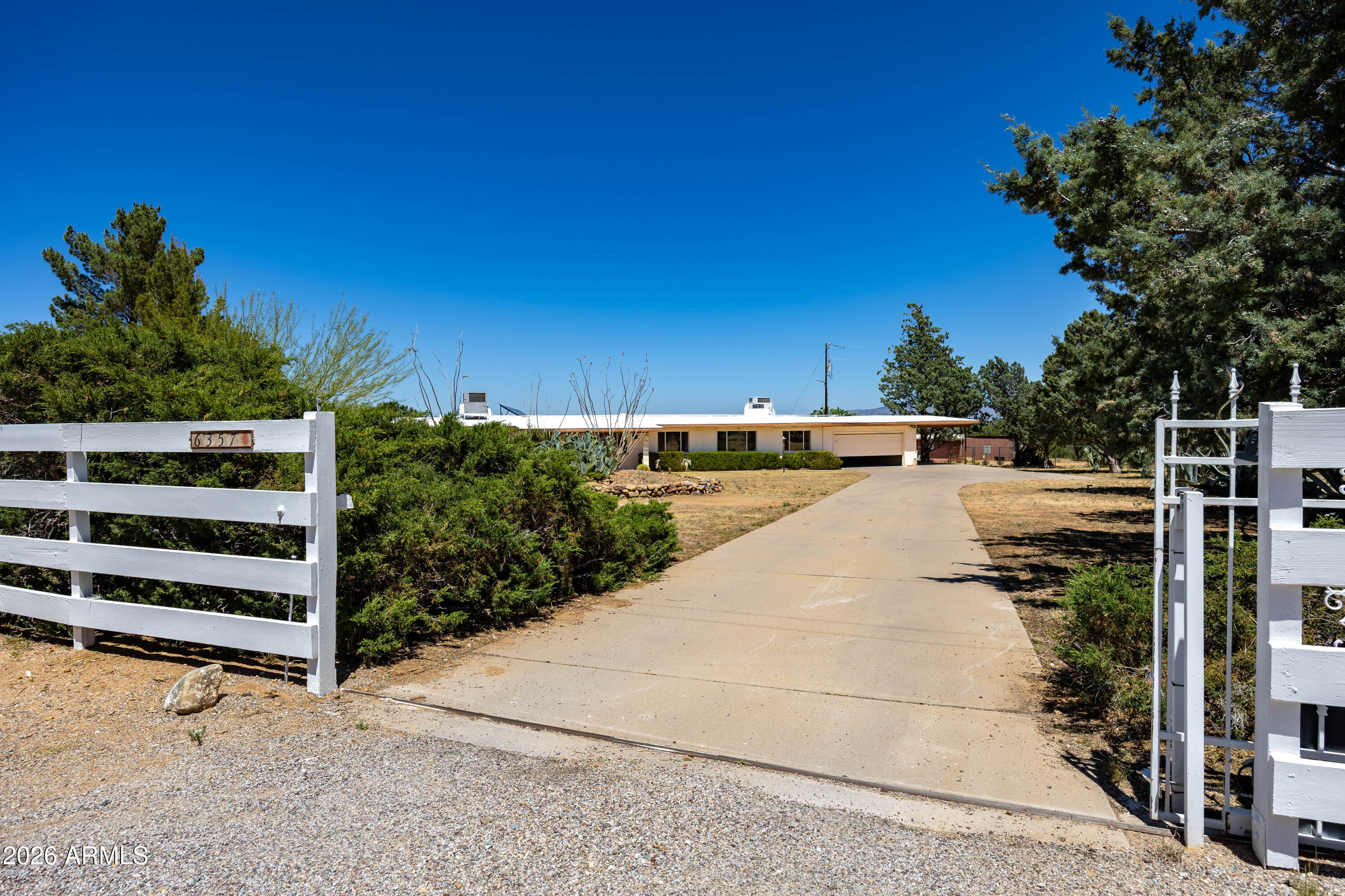 SPACIOUS RANCH HOME WITH GUEST QUARTERS, HORSE BARN & EXCERCISE/TRAINING RING ON 13.433 ACRES.
MOUNTAIN VIEWS!! OWNED SOLAR. PRIVATE WELL. 2 SEPTICS. 2 A/C UNITS. NATURAL GAS FOR HEATING, HOT WATER & FIREPLACE. BEAUTIFUL KITCHEN, LAMINATE & TILE FLOORS. 2 AZ ROOMS. FULLY FENCED & CROSSED FENCED. DOUBLE GARAGE & 1 CARPORT. LOTS OF STORAGE!