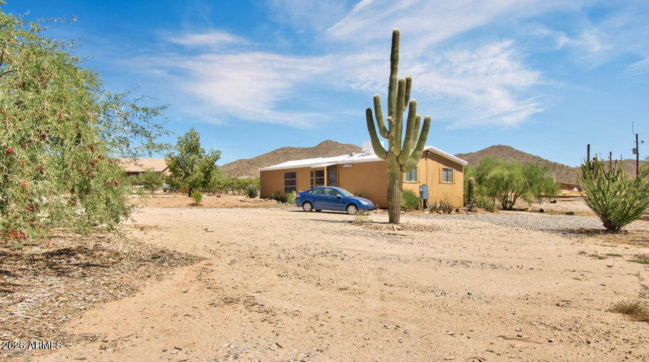 Nearly an acre of horse property in a desirable location with scenic views, usable land, and no HOA! This fully fenced property features a livable manufactured home with a split floor plan, vaulted ceilings, laminate flooring in main living areas, spacious living and dining areas, and a cozy iron fireplace. The kitchen offers ample cabinetry, matching appliances, and a breakfast bar. The primary suite includes dual sinks and generous space. A 2,500-gallon water tank, storage shed, ample parking, and room for horses, RVs, trailers, or future improvements add to the appeal. Surrounded by luxury homes and ongoing growth, this property offers exceptional potential. Sold as-is. Buyer to verify all facts, figures, and intended use.