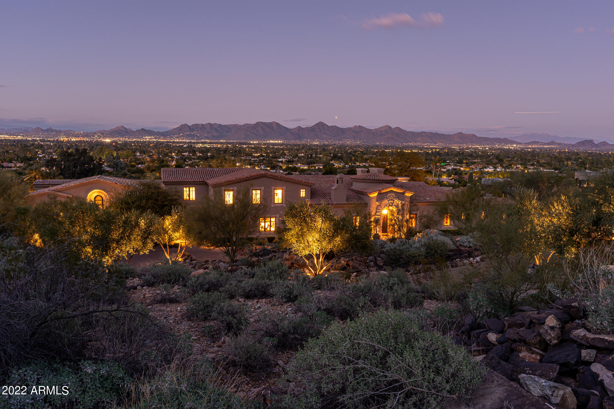 Stunning panoramic views and clean lines on this European style home on Mummy Mountain, exceptional craftsmanship with 3 hand carved French limestone fireplaces,  gorgeous cabinetry, trey ceilings, crown molding and a paneled study.  The home is situated with North/South exposure and views overlooking Paradise Valley, North Scottsdale, and the McDowell mountains and not only are the views expansive, put the lot itself has a gated paver drive for parking of 16+ cars.

Built in 2010, the 2 Bedroom guest house was designed by Brent Kendle and built by Kitchel. The Master bedroom is situated on the main floor while the three other ensuite bedrooms are located upstairs.

The basement features a media room, a game/play area and beautiful arched ceiling room that was a wine cellar (Second owner converted wine cellar to music room) 

The backyard has it all! Take a swim in the heated pool with a mother of pearl tile while soaking in the sun and taking in the expansive views from the travertine decking, built in BBQ or play a game of bocce ball on the real grass. 

The 2 Bedroom guest house has endless potential for you to make it your own, whether you are looking for an entertaining space, car display or art studio. On the main level you have the laundry, kitchenette, bathroom and bedroom. The downstairs bedroom suite has a private patio and  views and is plumbed for a stacking washer and dryer.