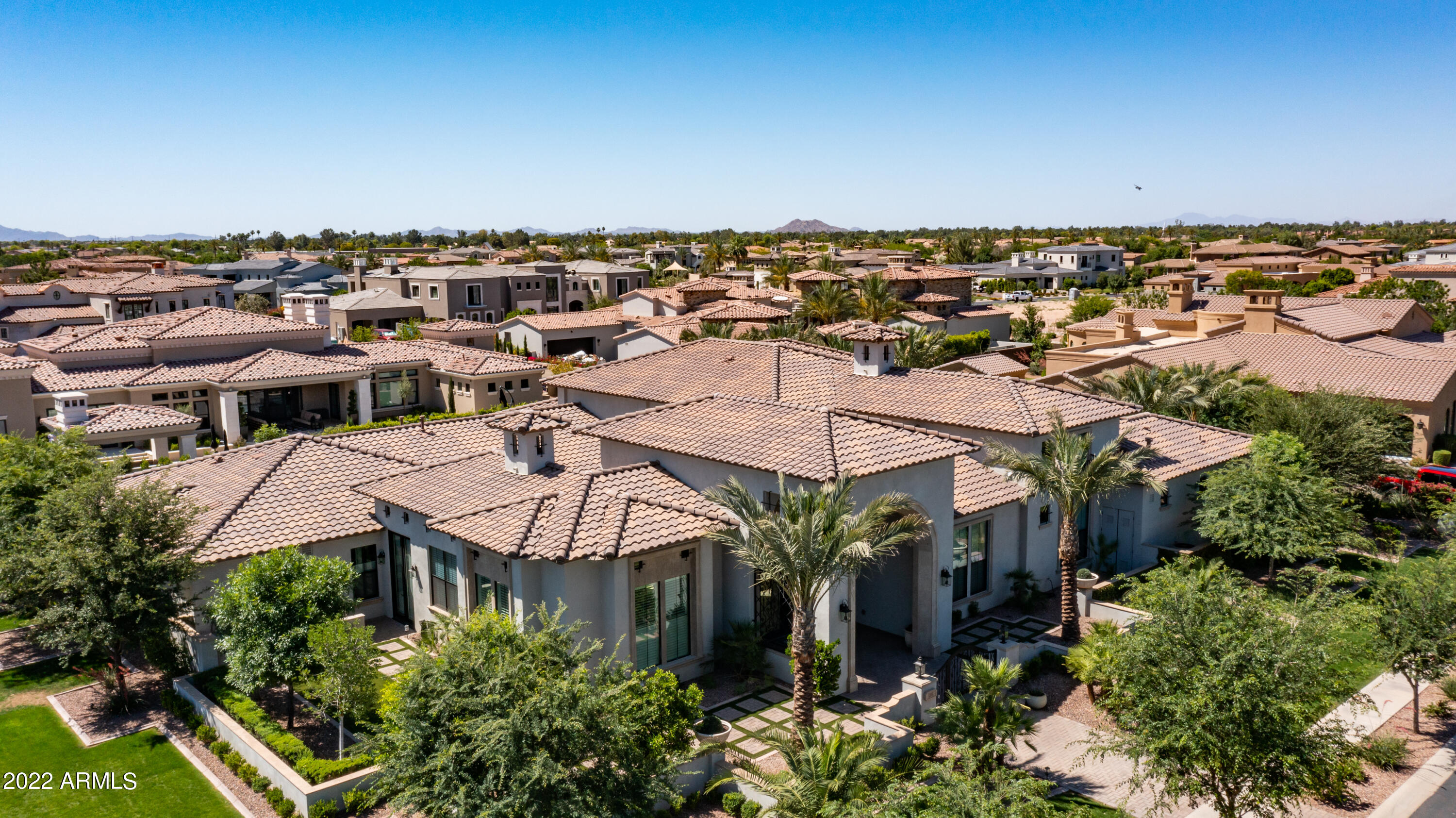 Premier Luxury Estate on the Exclusive Gated Island at Fulton Ranch. Featuring 6,981sf, 1/2 Acre Corner Lot, 5 bedrooms/5 bathrooms, 2 Offices, Bar/Bev Area, Butler Pantry, 2 Primary Suites, 5 Fireplaces, Electronic Shades, Large  Interior Courtyard & Resort Backyard. No Expense was Spared on Recent Upgrades/Renovations. Magazine Worthy   Fully Renovated Primary Owners Suite w/Rare 2 Story His/Her Closet w/Elevator, Miele Stacked Washer/Dryer & Expansive Glass Built-Ins by Classy Closets, Separate Miele Coffee Wet Bar w/Copper Sink & Beverage Cooler, Spa Retreat Bathroom w/Bain Ultra Aromatherapy Jet Tub, Fireplace, Designer Lighting/Plumbing Fixtures & Toto Toilet. Savant Smart System comes w/this Home as well as Surround Sound and All TV's. Up to 20' Ceilings Throughout. Chefs Kitchen Features Massive Double Island Quartz Counters, New Miele All-In-One Range includes Gas, Electric, Steam Oven, Built-in Microwave and Warming Drawer, Huge Walk-in Pantry. Bonus Room used as an Office can be a Game Room/Theater Room. Enter your Luxe Resort-Style Backyard w/Covered Patio, New Ramada, Full Outdoor Kitchen, 2-Way Limestone Fireplace. Refreshing Crystal Clear Heated Play Pool w/Baja Shelf & Poolside Seating Area & Water Feature w/Firepots. Temperature Controlled 4 Car Garage. Too Many Features to List on this Meticulously Maintained Home. This is a Special One Of A Kind Estate on The Island of Multi-Million Dollar Luxury Homes. In Fulton you will find Flowing Streams, Waterfalls & Scenic Walking Paths. Close Proximity to Restaurants, Golf Courses, Premier Shopping and 22 miles from Phoenix Sky Harbor Airport.