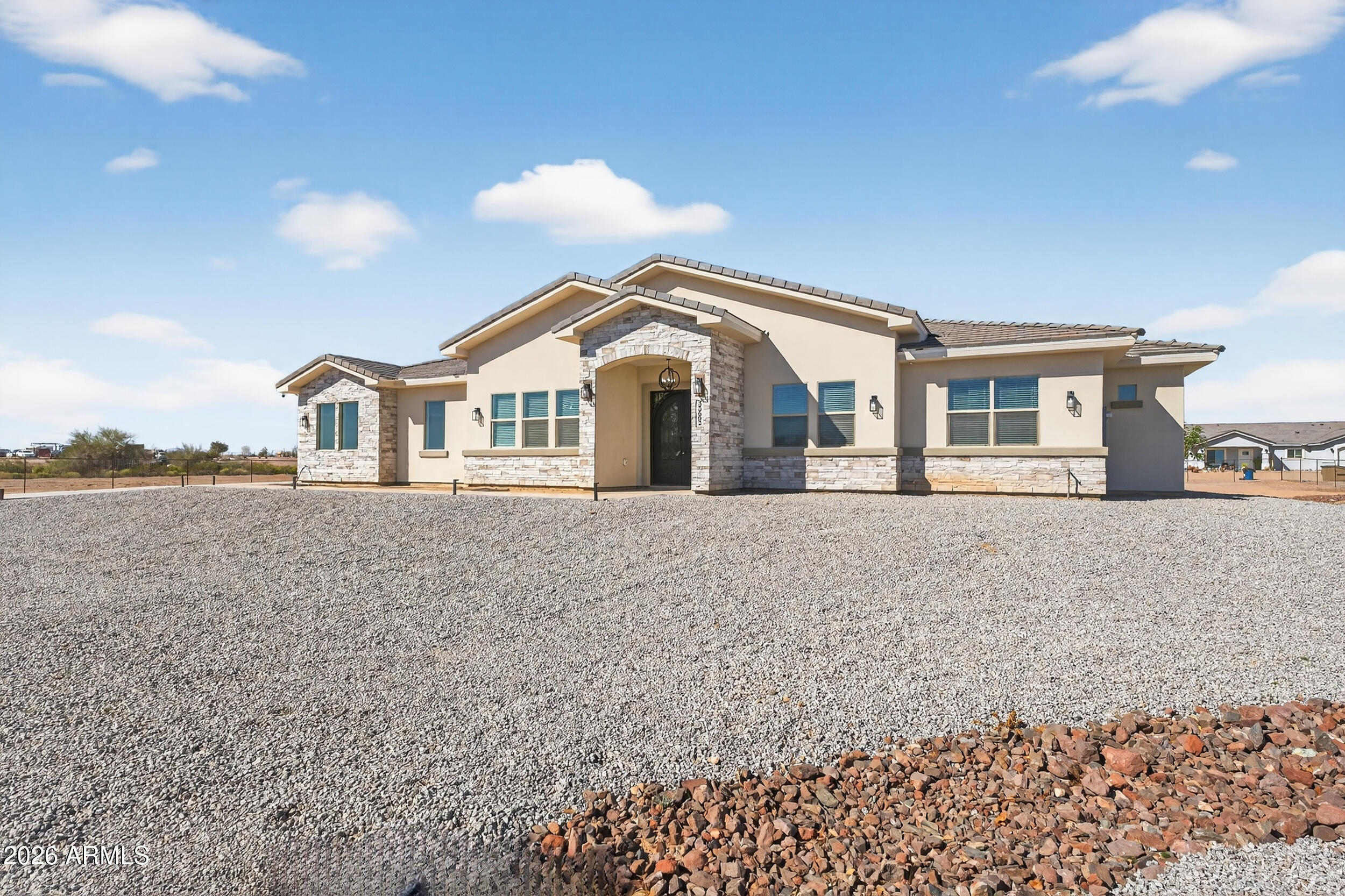 Experience the freedom of wide-open space without sacrificing luxury in this gorgeous custom Tonopah home.  Nestled on a fully fenced acre-plus lot, this 3 bedroom + den residence offers a formal dining room, spacious great room, and a layout designed for both entertaining and everyday comfort. Bring your RV, horses, toys or future plans - there's room for it all.  Enjoy peaceful desert sunsets, star-filled skies, and the privacy you've been looking for, all while living in a home loaded with upgrades and thoughtful finishes.