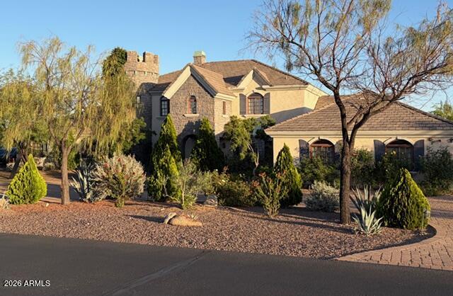 Horse Country Estate with Old World Charm! Timeless classic dark Alder wood with ornate trim everywhere, along with upgraded features like rounded corners, architecture that features triple radius arches, and radius top doors. Kids love the huge garden, water slide, secret door, and turret.  Enormous master upstairs over 900 sf, with luxurious bathroom, 2 walk in closets, retreat room, and a spacious wood floor for dancing!  Horse lover's dream with a gorgeous custom stables matching home. 4 custom iron and wood stalls. Stables has cinder block, fire board and fire sprinklers. Horse stalls have 120 foot paddocks framed by mature mesquite trees for shade. 2.89 acre property has perimeter fencing, stone pillars with lights, and custom iron gates. Community is also gated.  Owner Agent Listing