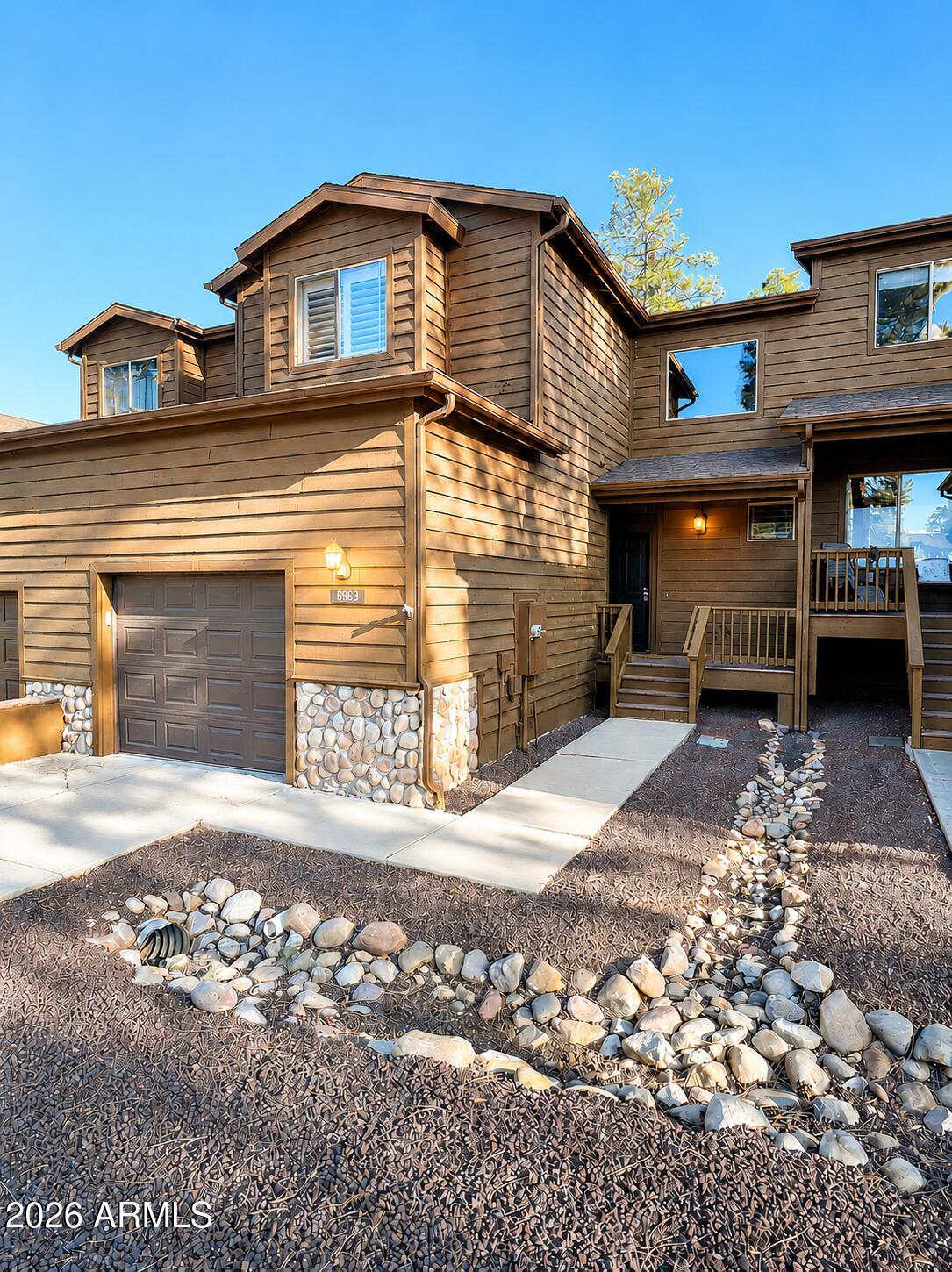 Nestled in the desirable Starlight Ridge community, this FULLY FURNISHED cozy 3-bedroom, 3-bath townhome offers the perfect blend of mountain charm, comfort, and low-maintenance living and comes fully furnished, making it truly move-in ready!  From the moment you step inside, you're welcomed by a beautiful foyer featuring a stunning log-style staircase that opens into the spacious dining area, kitchen, and great room.
The great room showcases soaring ceilings with gorgeous pine tongue-and-groove finishes, abundant natural light, and a striking stone electric fireplace that creates the perfect mountain retreat atmosphere. The functional kitchen features beautiful hickory cabinetry and plenty of workspace for everyday living or entertaining.
The downstairs bedroom offers... convenient access to a full bath with a private entry, making it ideal for guests. Upstairs, the spacious primary suite includes two closets and a private ensuite bath. The loft area provides the perfect bonus entertainment space complete with shuffleboard, darts, ring toss, and additional seating for relaxing or hosting family and friends.
Additional highlights include sold fully furnished for an easy transition or turnkey vacation home opportunity,  upgraded carpet and interior paint throughout,  attached garage with extensive built-in cabinetry for exceptional storage,  private back deck with no homes directly behind and easy lock and leave lifestyle.  
Perfectly located near National Forest hiking trails, this home places you in the heart of Arizona's breathtaking White Mountains.
Experience all four seasons while enjoying fresh mountain air, 40 lakes, and over 600 miles of rivers and streams. Outdoor enthusiasts will love the extensive trail systems for hiking, biking, horseback riding, ATV adventures, and more. Sunrise Ski Resort is just 40 minutes away for skiing, snowboarding, and winter fun across three beautiful mountains.  The area also offers antique shopping and seasonal arts & crafts festivals, Music Festivals and community events year-round and seven incredible golf courses, including three public courses.   Pinetop-Lakeside has even been voted one of the "Best Cabin Regions in the U.S." Come discover why the White Mountains are Arizona's best-kept secret!
