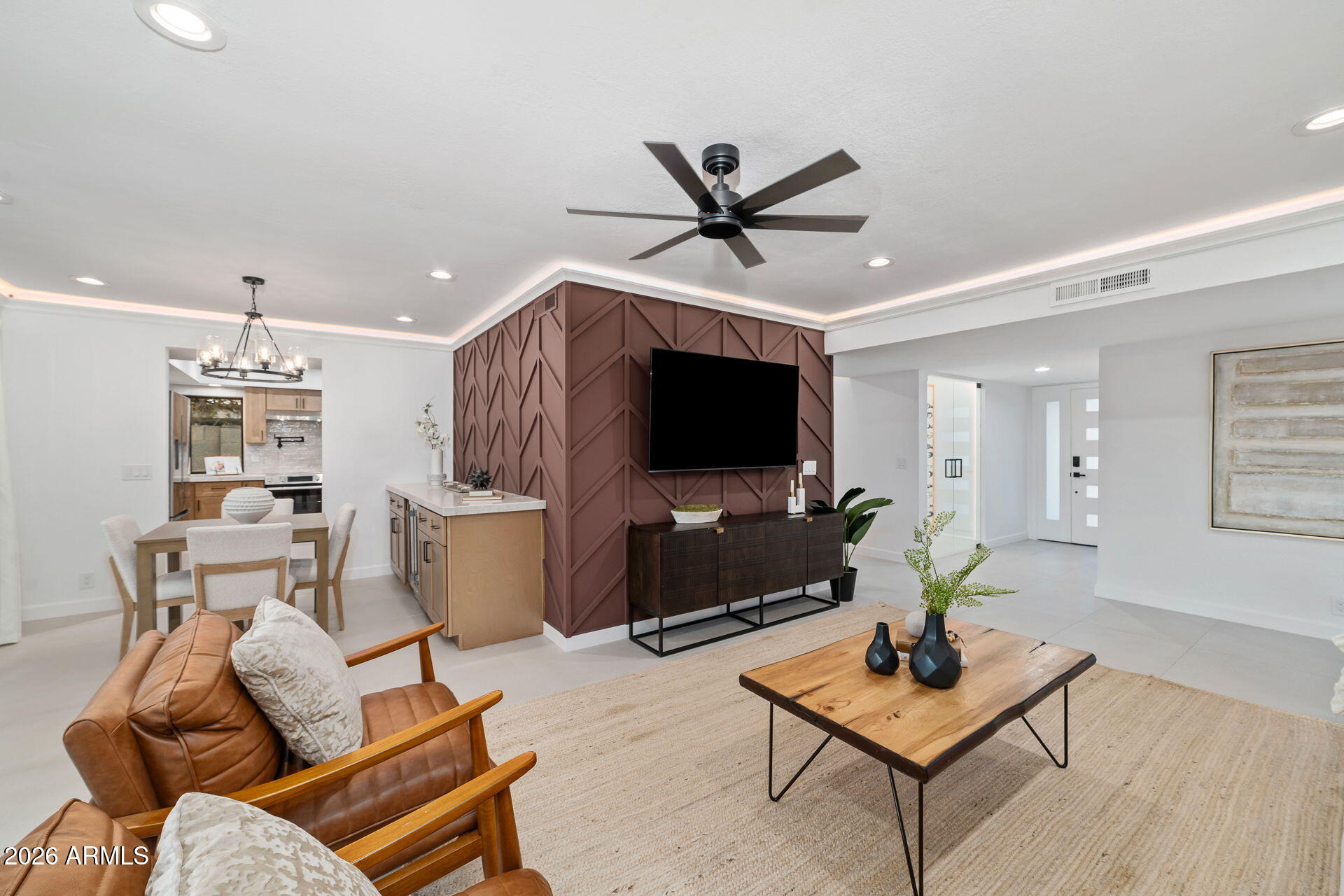 This refined McCormick Ranch remodel blends modern luxury with timeless comfort, offering a true turnkey living experience.  Updated from top to bottom in 2026, the home delivers a level of finish rarely seen in this sought-after floor plan. Step inside to an open, light-filled layout featuring new windows and doors, new designer flooring, fresh interior paint, and a fully reimagined kitchen and bathrooms. The chef's kitchen showcases new appliances, including a built-in coffee maker and combo microwave/speed oven, along with custom cabinetry and premium finishes. A striking glass-enclosed wine display anchors the main living space with a high-end architectural touch. Additional upgrades include a new roof, hot water heater and water softener, hot tub, and an upgraded electrical panel. AC unit replaced  (Dec 2024). A versatile 460 sq ft climate-controlled garage/flex suite--finished with designer lighting, mini-split, dog wash, and epoxy--offers an elevated environment for work, wellness, or creative pursuits. Not included in sq ft.