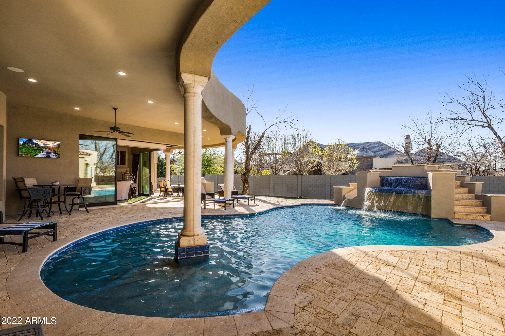 Exquisite custom home featuring timeless architecture in the highly sought after neighborhood of The Pecans. Nestled in a cul de sac, this  home invites a feeling of privacy and tranquility. The light filled great room and kitchen with a disappearing wall of glass lead to multiple covered patios, misting system, heated pool with water feature, sport court, batting cage and in ground trampoline. Serene primary retreat will not disappoint with a huge ensuite, spa tub, double entry shower and designer closet. Split are 4 additional ensuite bedrooms, teen room, gym and sauna with outdoor access. Unsurpassed classic style brings you to the theater room with Control 4 system, seating for 10,multi screen media room, pool table and Brunswick Bowling alley. Snack bar, pebble ice, 2 additional powder rooms and 4 car garage with storage room are additional features in this unmatched luxury estate!