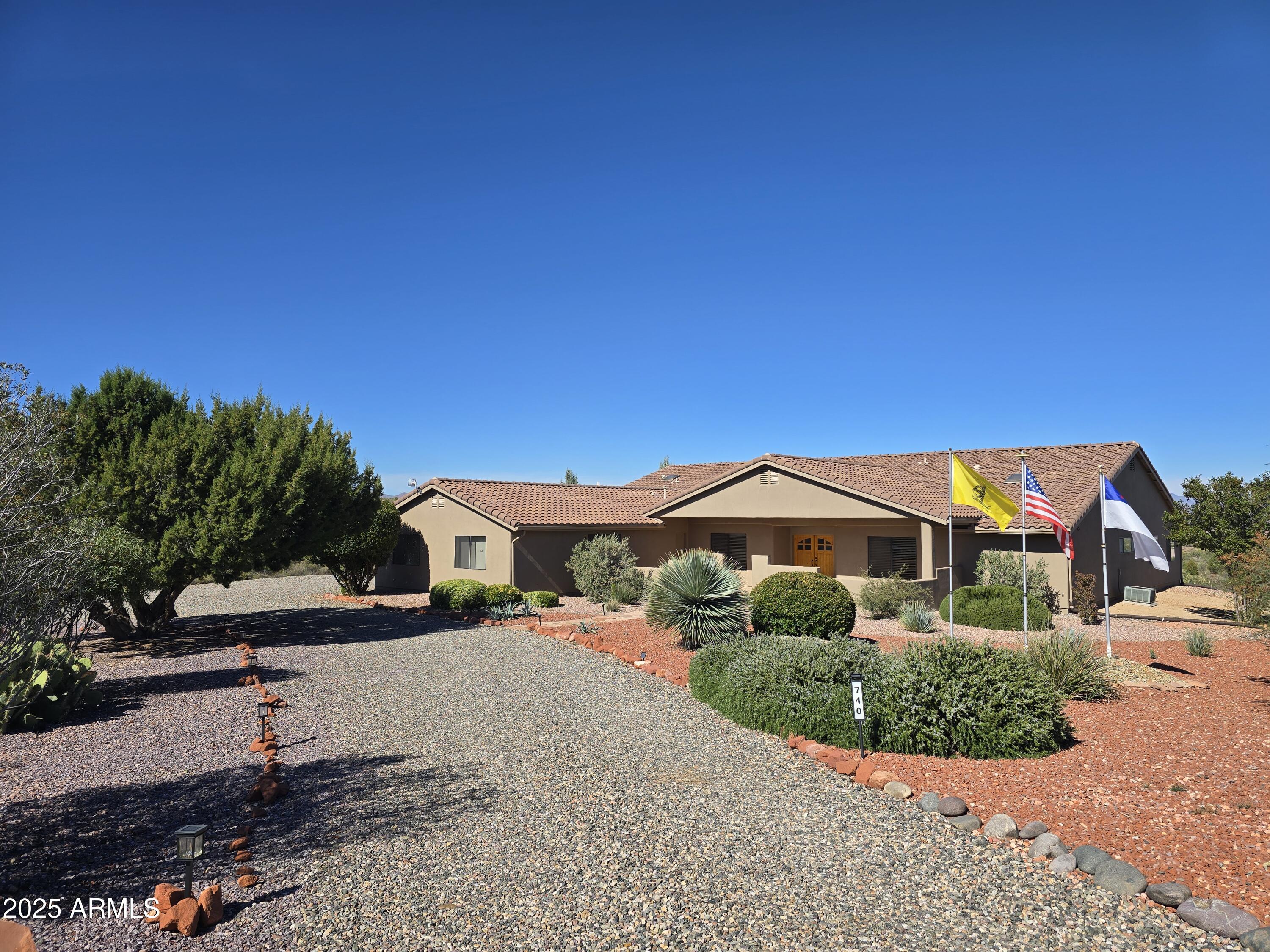 Discover the epitome of luxury living in this stunning custom ranch hilltop residence, boasting 4 spacious bedrooms and 3 elegant baths within a generous 3,468 square feet—breathtaking panoramic views of red rock formations, & majestic mountains. Enjoy the beauty of low-maintenance indigenous landscaping that harmonizes with the natural surroundings. Laminate flooring that flows seamlessly throughout the home, enhancing its warmth and charm. The enormous living area has a hickory custom kitchen and dining space. Large covered back patio, with views of the Red Rocks. An extra-deep 3-car garage measuring 36x26 offers ample space for outdoor toys, a workshop, and multiple vehicles. No HOA restrictions, freshly painted interiors make it immaculate and move-in ready.
