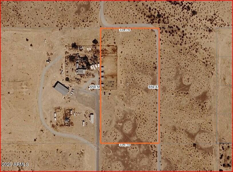 5+ Acres with seller financing. Great access to your new spot with paved roads from the I-10 to Elliott Rd and just a short drive up the well maintained 391st Ave.  Partially fenced with power on the property line. Flat land with natural vegetation. Mountain views and lots of room for your home and projects. The horse/cow corrals can stay with the property if buyer would like to have them. Seller is offering financing with 20% down. No HOA, no credit check. Build what you want when you want. If you like peace & quiet, rural areas and paved roads, this is the one for you!