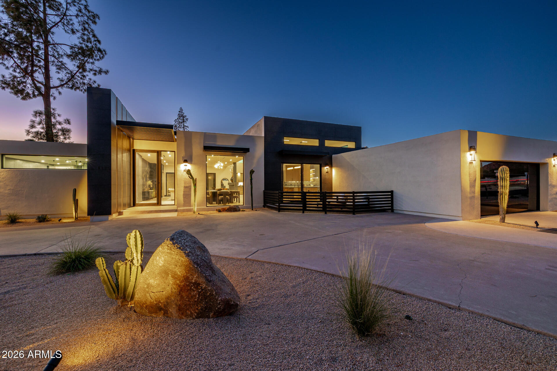 THE LIGHTHOUSE, a striking expression of modern desert luxury in Camelback Canyon Estates. Thoughtfully designed by Gregg Properties and Rise Value Company to capture an abundance of natural light, this residence frames picturesque views of Camelback Mountain from nearly every vantage point. Finishes are meticulously curated in warm, earthy tones with a subtle nod to old Hollywood sophistication.

Soaring ceilings and expansive walls of glass create a seamless indoor-outdoor experience, allowing the living and dining spaces to flow naturally into the private courtyard beyond. Designed for contemporary living, this home features custom designer cabinetry, a high-performance appliance package, a butler's pantry, and two laundry rooms--balancing architectural beauty with everyday practicality. The primary suite wing is a true retreat, offering dual bathroom spaces, a generous walk-in closet, a second laundry, and a private wellness room. Outdoors, entertain around the dramatic infinity fountain, heated smart pool and spa, and desert-friendly landscaping that blends effortlessly with the surrounding Camelback terrain.

Ample parking includes a two-car garage, circular driveway, and additional utility access. Ideally located just minutes from The Global Ambassador, along with Paradise Valley and Arcadia's most celebrated dining and shopping, THE LIGHTHOUSE offers refined living at the center of Phoenix's most coveted lifestyle.