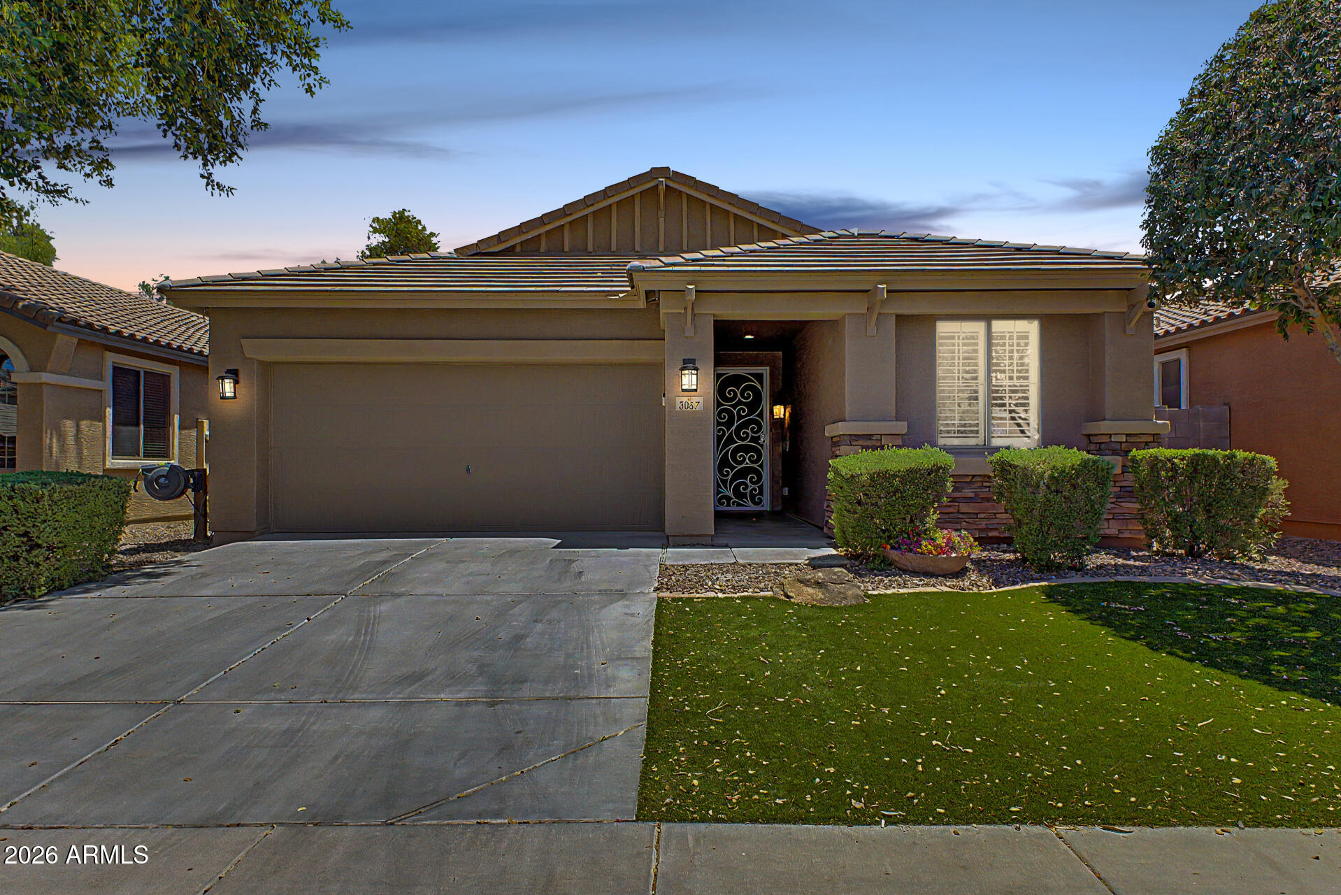 Exceptional single-story former model home with beautiful under-eave exterior lighting, located in the Spectrum Community, offers access to lush neighborhood parks. Showcasing premium upgrades throughout, the home features fresh neutral paint inside & out, luxury vinyl plank flooring with no carpet, elegant plantation shutters, custom window treatments & sophisticated built-in cabinetry in the family room, office/den & hallways. The open-concept gourmet kitchen features granite counters, tile backsplash, abundant cabinetry, stainless steel appliances & an integrated surround sound system. The spacious primary suite provides a private retreat with a double-sink vanity, relaxing soaking tub & custom-tiled walk-in shower. Backyard features a covered extended paver patio & Built in BBQ!